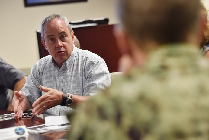 Christopher Zahner, left, 841st Transportation Battalion traffic manager, talks to Rear Adm. Lawrence Jackson, right, U.S. Transportation Command Strategy, Capabilities, Policy and Logistics Directorate outgoing director, during a mission briefing Aug. 1 at the Joint Base Charleston - Weapons Station as part of an orientation visit. Jackson and Rear Adm. Peter Clarke, USTRANSCOM Strategy, Capabilities, Policy and Logistics Directorate incoming director, received a 437th Airlift Wing mission briefing, observed demonstrations and toured a C-17 Globemaster III and the 437th Aerial Port Squadron during the visit. USTRANSCOM is a unified, functional combatant command which provides support to the eight other U.S. combatant commands, the military services, defense agencies and other government organizations by providing full-spectrum global mobility solutions and related enabling capabilities for supported customers’ requirements in peace and war.