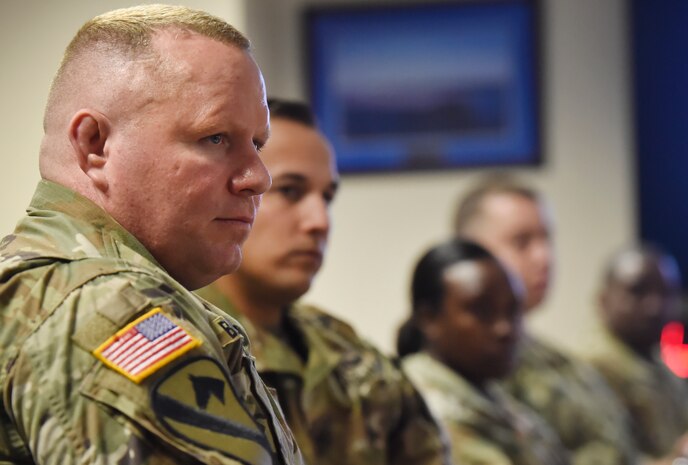 Lt. Col. Chad Blacketer, left, 841st Transportation Battalion commander, and soldiers from the 841st TRANS BTN, listen to feedback given by Rear Adm. Lawrence Jackson, U.S. Transportation Command Strategy, Capabilities, Policy and Logistics Directorate outgoing director, and Rear Adm. Peter Clarke, USTRANSCOM Strategy, Capabilities, Policy and Logistics Directorate incoming director, at the end of a mission briefing Aug. 1 at the Joint Base Charleston - Weapons Station as part of an orientation visit. Jackson and Clarke received a 437th Airlift Wing mission briefing, observed demonstrations and toured a C-17 Globemaster III and the 437th Aerial Port Squadron during the visit. USTRANSCOM is a unified, functional combatant command which provides support to the eight other U.S. combatant commands, the military services, defense agencies and other government organizations by providing full-spectrum global mobility solutions and related enabling capabilities for supported customers’ requirements in peace and war.