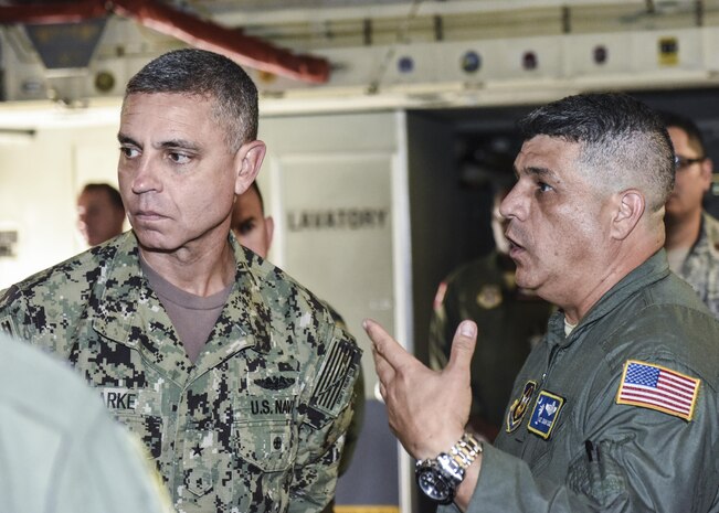 Master Sgt. Johnny Gomez, right, 315th Aeromedical Evacuation Squadron NCO in charge of aircrew training,  explains the unit’s aeromedical evacuation process Aug. 1 on a C-17 Globemaster III to Rear Adm. Peter Clarke, left, U.S. Transportation Command Strategy, Capabilities, Policy and Logistics Directorate incoming director,  during an aeromedical evacuation demonstration here. USTRANSCOM is a unified, functional combatant command which provides support to the eight other U.S. combatant commands, the military services, defense agencies and other government organizations by providing full-spectrum global mobility solutions and related enabling capabilities for supported customers’ requirements in peace and war.