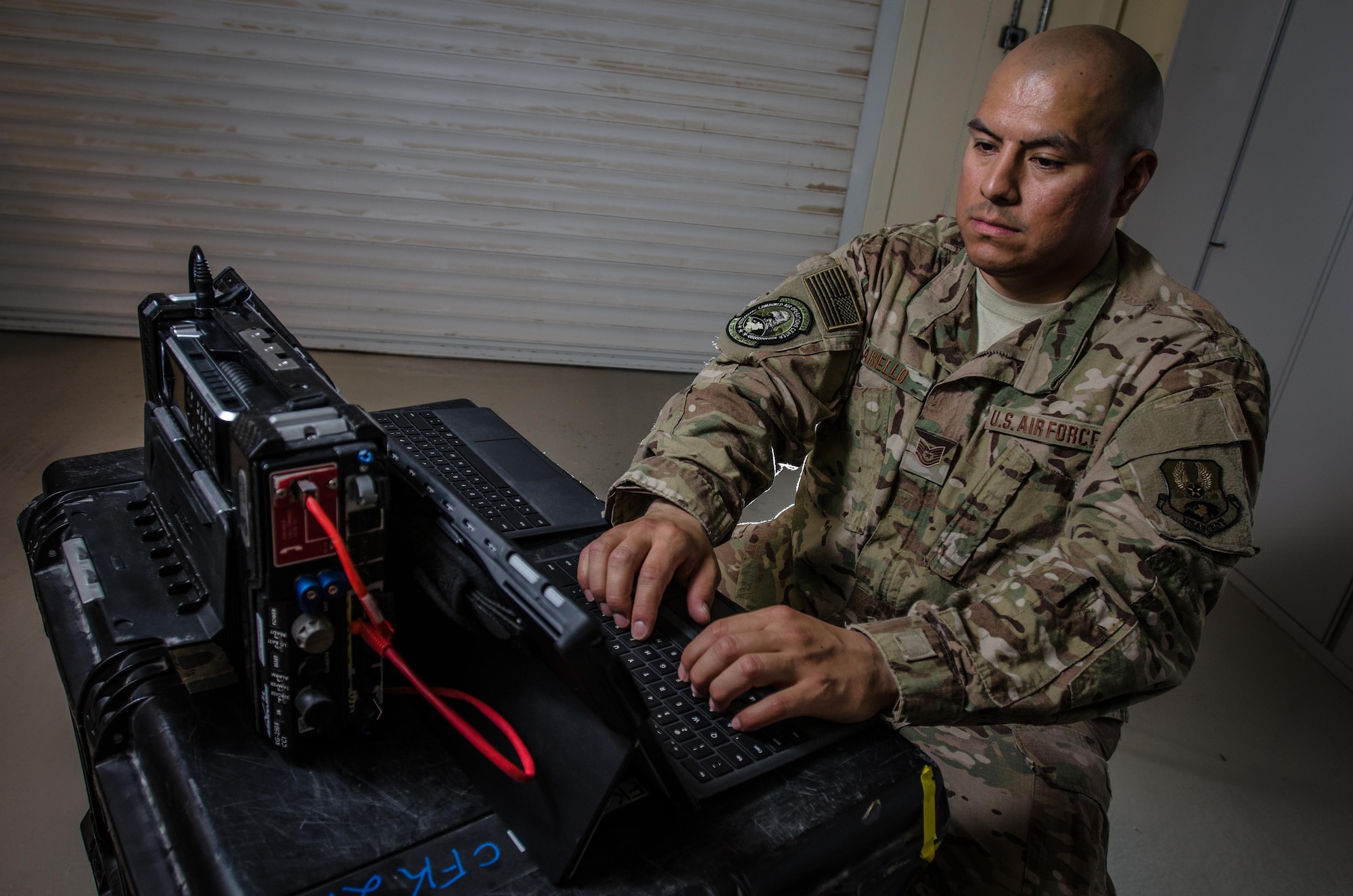 U.S. Air Force Tech. Sgt. Albert Cabello,the 609th Expeditionary Air and Space Communications Squadron NCO in charge of executive communications, tests Combined Air Operations Center, tests the new executive  kit Aug. 1, 2017, at Al Udeid Air Base, Qatar. Cabello provides secure command and control network communications for key Air Force leaders via commercial medians and establishes voice, video, e-mail, and data services using the new ECK. (U.S. Air Force photo by Staff Sgt. Alexander W. Riedel)