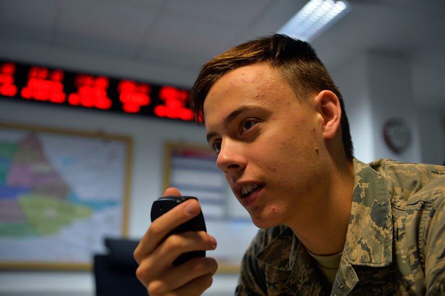 U.S. Air Force Airman 1st Class Jackson Dollar, 86th Airlift Wing Command Post junior controller, tests the Giant Voice public announcement system on Ramstein Air Base, Germany, Aug. 2, 2017. Command post is responsible for sending emergency notifications to units, managing the emergency mass notification system, and providing command and control support to operations coming in and out of Ramstein. (U.S. Air Force photo by Airman 1st Class Joshua Magbanua)