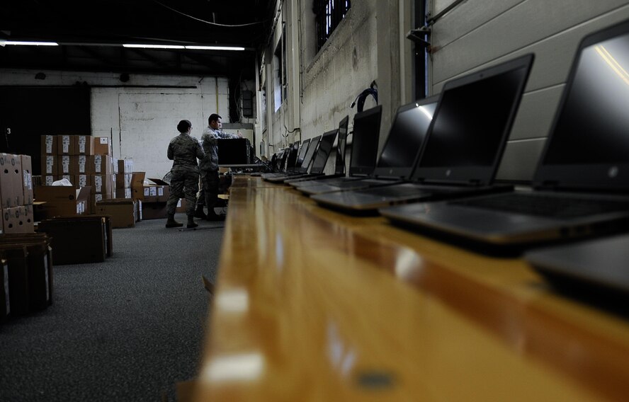 Senior Airman Eric Contreras, right, and Airman 1st Class Laura Carlson, 86th Communications Squadron systems acquisitions technicians, connect computers to the network for imaging on Ramstein Air Base, Germany, Aug. 3, 2017. Having the latest and greatest technology at their fingertips, service-members have the assurance of a more secure machine and communication with the recent Microsoft Windows 10 update. (U.S. Air Force photo by Airman 1st Class Savannah L. Waters)
