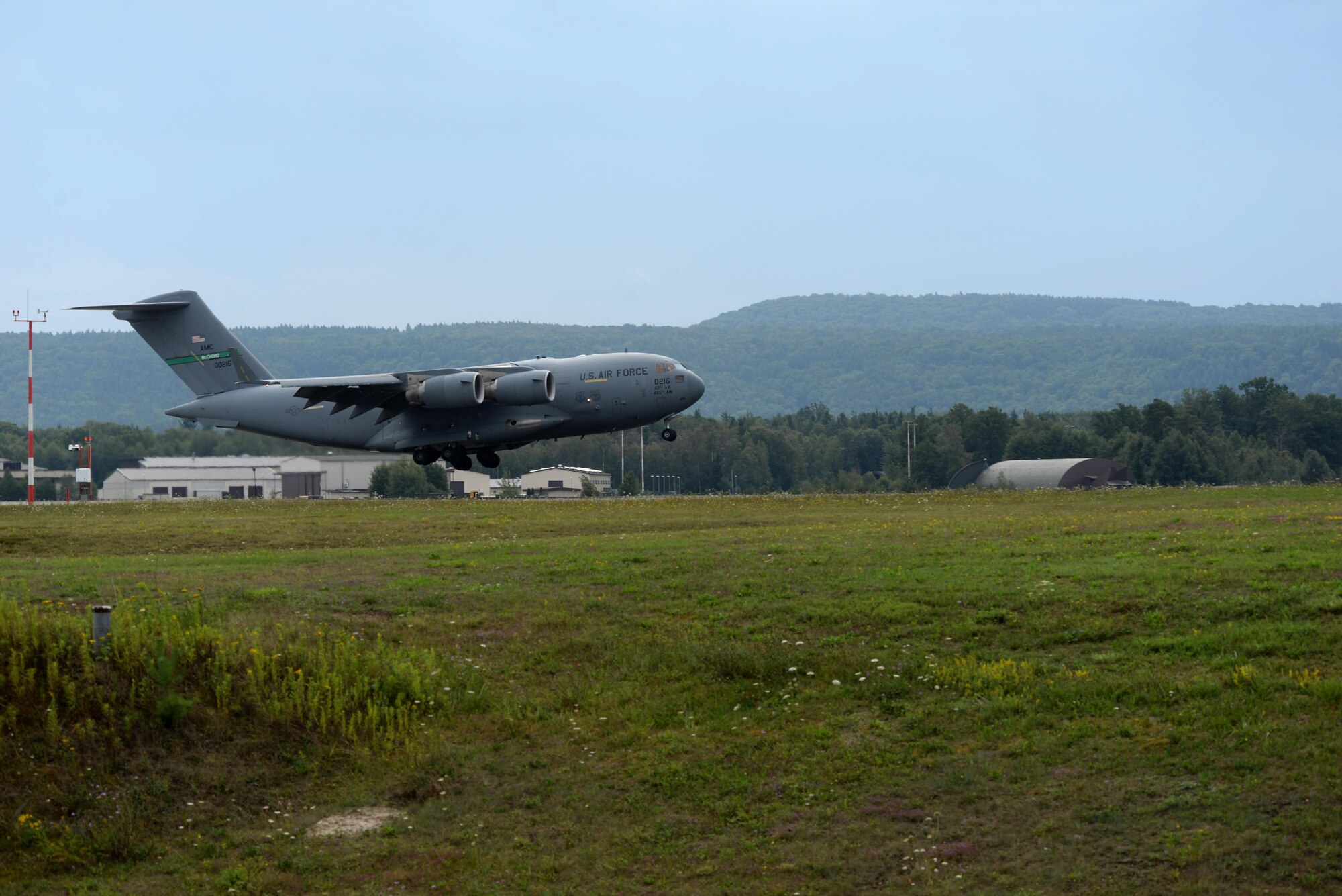 A C-17 Globemaster III lands on a runway on Ramstein Air Base, Germany, Aug. 3, 2017. The objective of aircrafts assigned to Ramstein Air Base are to assist United States forces and allies with world-class airlift and expeditionary combat support in both peace and war situations. The 1952 location of Landstuhl Air Base’s airstrip is now Ramstein Air Base’s Kisling Memorial Drive, the main road linking the east and west gates. (U.S. Air Force photo by Airman 1st Class D. Blake Browning)