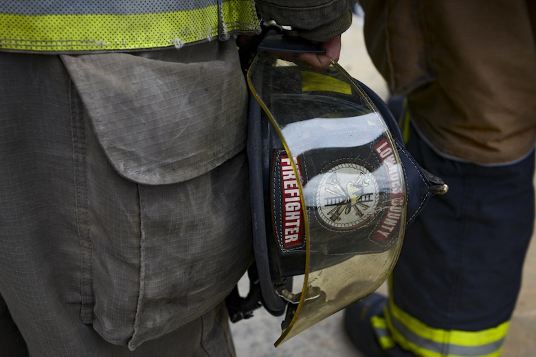 A Lowndes County firefighter holds his helmet, Aug. 3, 2017, at Moody Air Force Base, Ga. Rapid intervention refers to the rescue of downed firefighters when they find themselves in trouble. During the course, Moody firefighters, as well as a Lowndes County firefighter, learned how to perform self-rescue, team rescue, and basic skills such as CPR and various carries in order to transport victims. (U.S. Air Force photo by Airman 1st Class Lauren M. Sprunk)