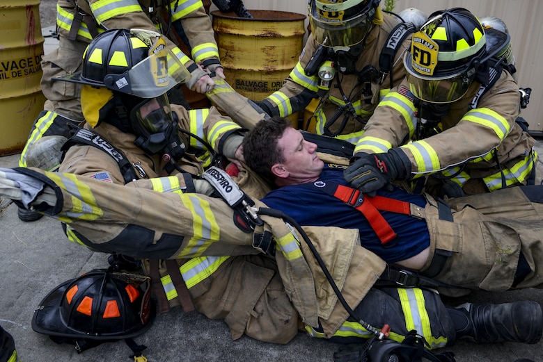 Firefighters from the 23d Civil Engineer Squadron simulate CPR on a victim during rapid intervention fire training, Aug. 3, 2017, at Moody Air Force Base, Ga. Rapid intervention refers to the rescue of downed firefighters when they find themselves in trouble. During the course, Moody firefighters, as well as a Lowndes County firefighter, learned how to perform self-rescue, team rescue, and basic skills such as CPR and various carries in order to transport victims. (U.S. Air Force photo by Airman 1st Class Lauren M. Sprunk)