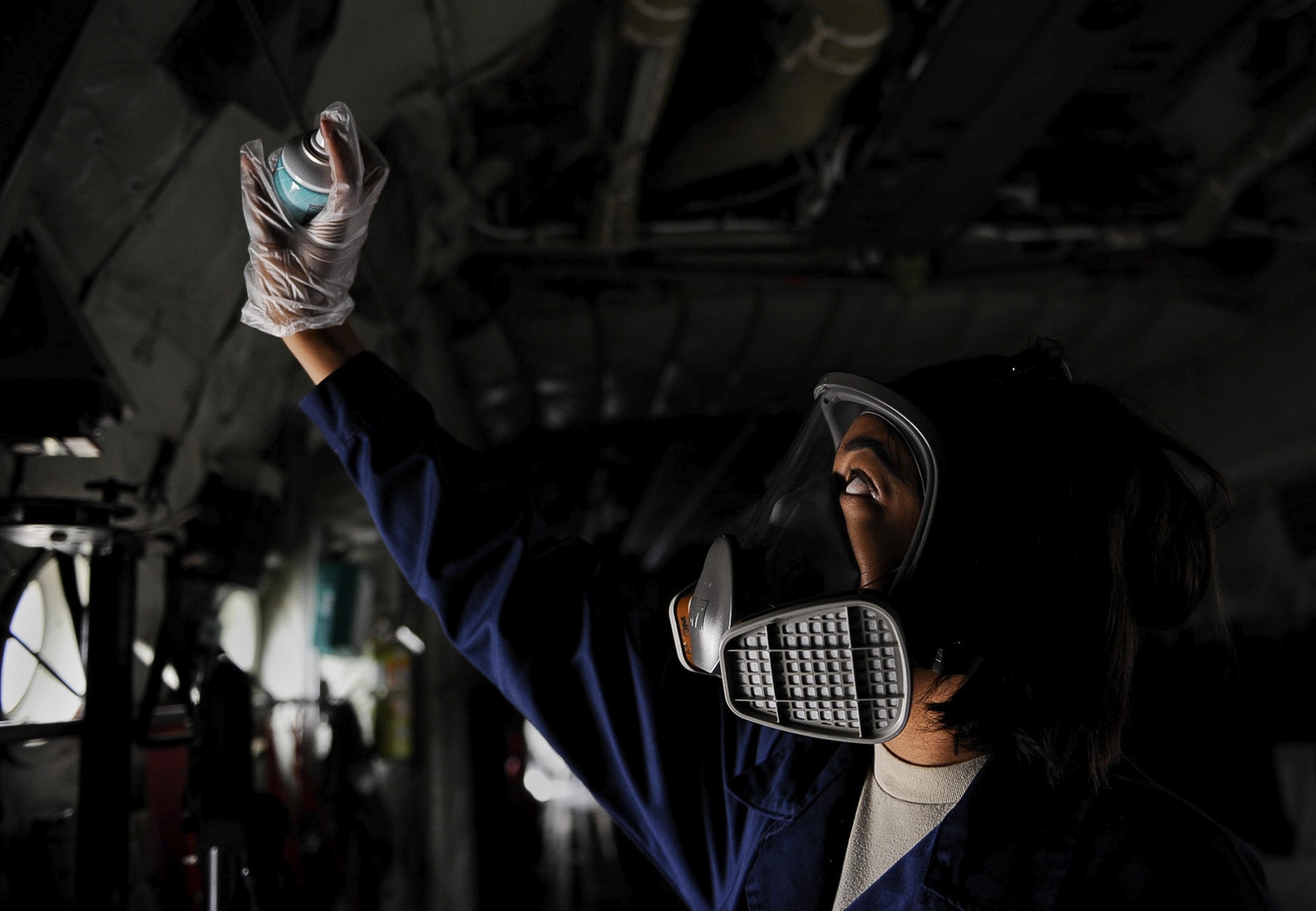 Airman 1st Class Arielle Howze, 786th Civil Engineer Squadron pest management journeyman, sprays aircraft insecticide inside a C-130 Hercules at Ramstein Air Base, Germany, July 27, 2017. Depending on the size of the aircraft, the spray needs anywhere from 30 minutes to an hour for aircraft treatment. (U.S. Air Force photo/Airman 1st Class Savannah L. Waters)