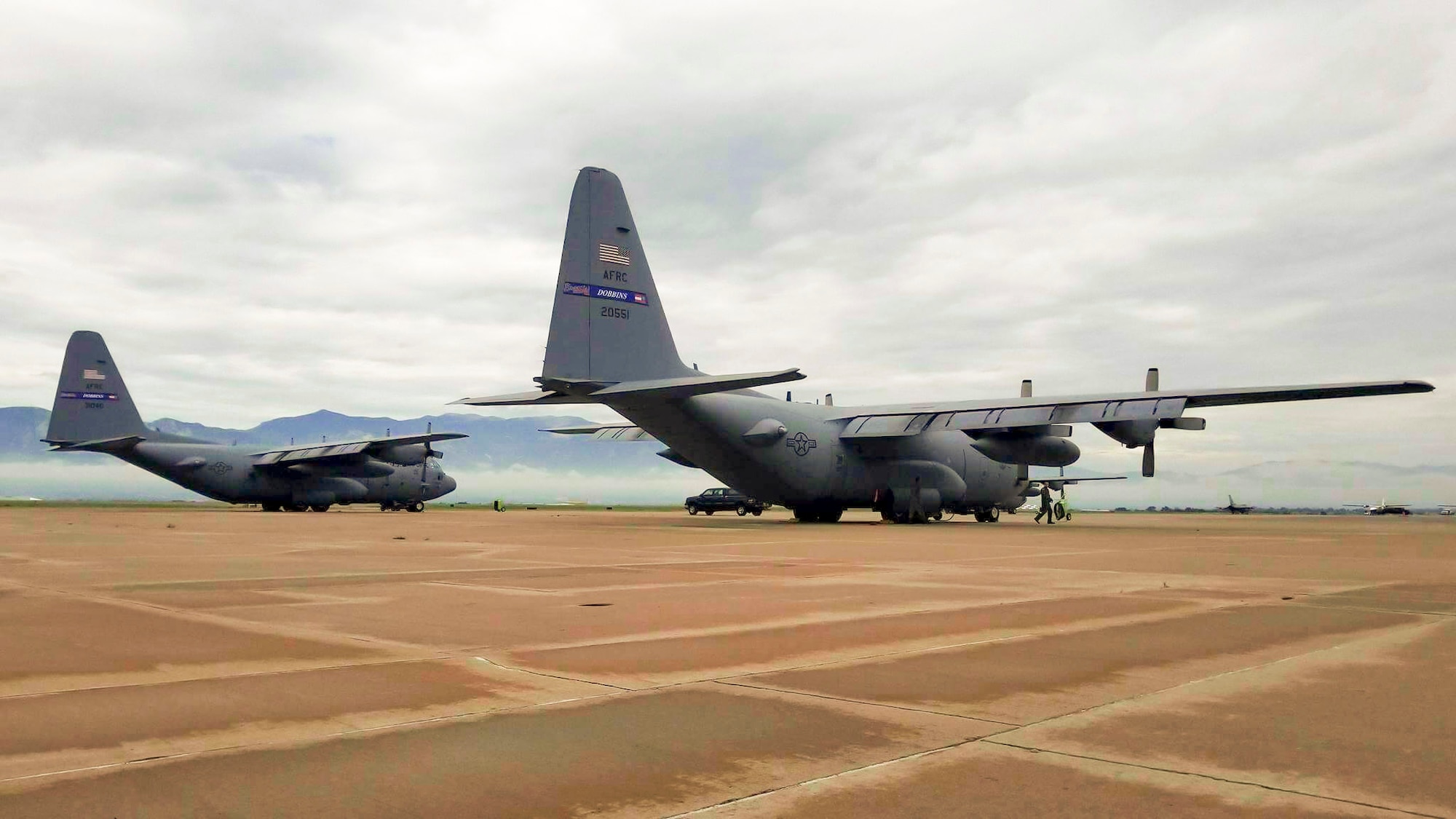 Two C-130H Hercules from the 94th Airlift Wing, Dobbins Air Reserve Base, Ga. are parked on the flightline at Peterson Air Force Base, Colo. Aug. 3, 2017. The two aircraft participated with other C-130s in high-altitude airdrops in the Colorado Rockies. (U.S. Air Force photo/Senior Airman Lauren Douglas)