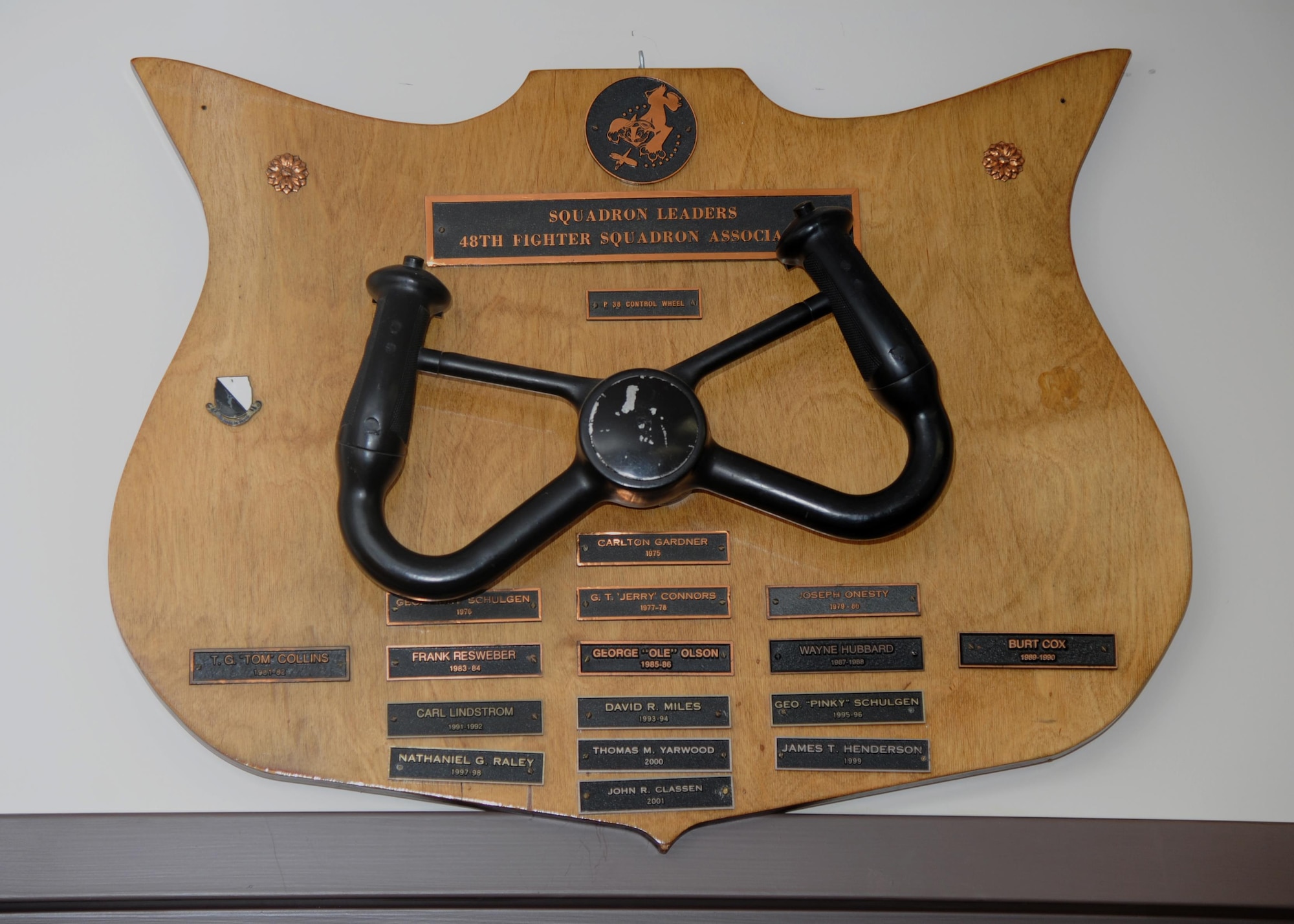 In the period of peace that followed World War II, the aircraft and missions of the 48th changed many times. The 48th Fighter Squadron Association was formed in 1975 to keep the heritage of the 48th Pursuit and Fighter Squadron alive and relevant to the current 48th members. This plaque, featuring the control wheel from a P-38 Lightning, recorded the presidents of the Association. (U.S Air Force photo by Airman 1st Class Beaux Hebert)