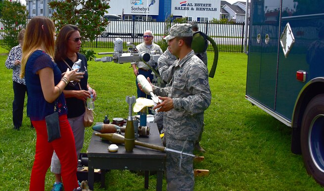 Members of the 166th Airlift Wing, Explosive Ordinance Disposal Team, explain some of the explosives they work to local business leaders during the Center of Influence Conference at Bethany Beach Training Site, Bethany Beach, De., 27 July 2017. (U.S. Air National Guard photo by SSgt. Andrew Horgan/released)