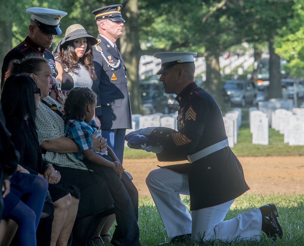 Sergeant Maj. Matthew R. Hackett, command sergeant major, Marine Barracks Washington D.C., passes the National Ensign to Sherry Jennings, spouse of Marine Sgt. Julian Kevianne, during a funeral for Kevianne at Arlington National Cemetery, Arlington, Va., Aug. 3, 2017. Kevianne, 31, was one of the 15 Marines and one Navy sailor who perished when their KC130-T Hercules crashed in Mississippi, July 10, 2017. He was part of the Marine Aerial Refueler Transport Squadron 452, Marine Aircraft Group 49, 4th Marine Air Wing, based out of Stewart Air National Guard Base in Newburgh, NY. (Official U.S. Marine Corps photo by Cpl. Robert Knapp/Released)