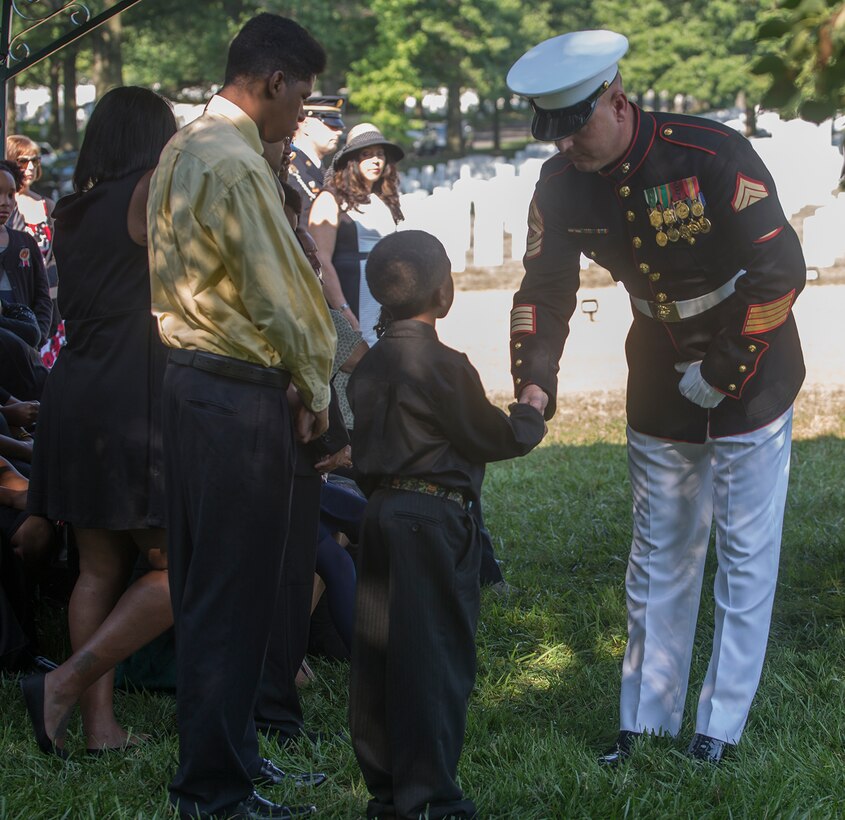 Master Sgt. Robert B. Antczak, funeral director, Marine Barracks Washington D.C., shakes the hand of a family member of Marine Sgt. Julian Kevianne at the conclusion of a funeral for Kevianne at Arlington National Cemetery, Arlington, Va., Aug. 3, 2017. Kevianne, 31, was one of the 15 Marines and one Navy sailor who perished when their KC130-T Hercules crashed in Mississippi, July 10, 2017. He was part of the Marine Aerial Refueler Transport Squadron 452, Marine Aircraft Group 49, 4th Marine Air Wing, based out of Stewart Air National Guard Base in Newburgh, NY. (Official U.S. Marine Corps photo by Cpl. Robert Knapp/Released)