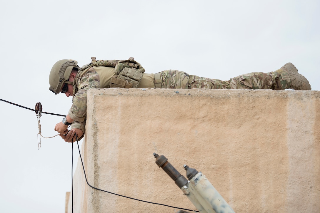 Air Force Senior Airman Jared Basham rigs a rope to open a door during the Raven's Challenge explosive ordnance disposal exercise at Camp Pendleton, Calif.