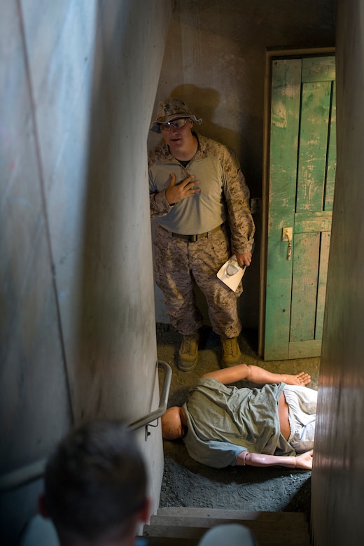 Marine Corps Gunnery Sgt. Brian Murphy introduces himself to role-playing terrorism victims during the Raven's Challenge explosive ordnance disposal exercise at Camp Pendleton