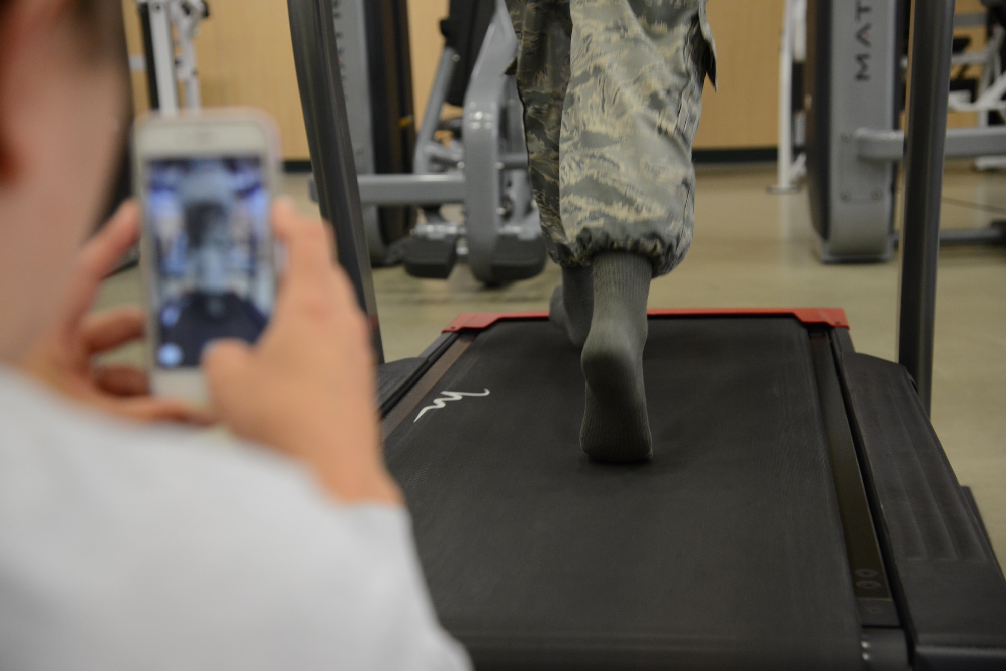 Staff Sgt. Adriana Bitker, 341st Medical Operations Support Squadron physical therapy technician, records treadmill running in slow motion during a running clinic Aug. 1, 2017, at Malmstrom Air Force Base, Mont.
