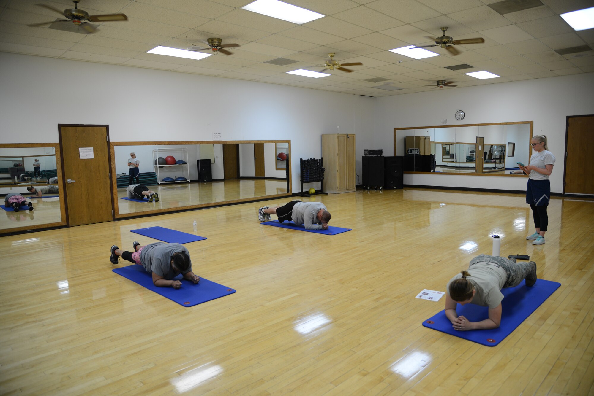 Staff Sgt. Adriana Bitker, 341st Medical Operations Support Squadron physical therapy technician, demonstrates a plank during a core stability class while Senior Airman Kaitlyn Callahan, 341st MDOSS physical therapy technician, monitors the timed exercise Aug. 2, 2017, at Malmstrom Air Force Base, Mont.