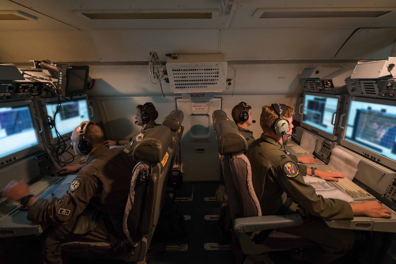 Air Force aircrew members from the Georgia Air National Guard's 116th Air Control Wing monitor surveillance data while flying a night mission aboard an E-8C Joint Surveillance Target Attack Radar System aircraft