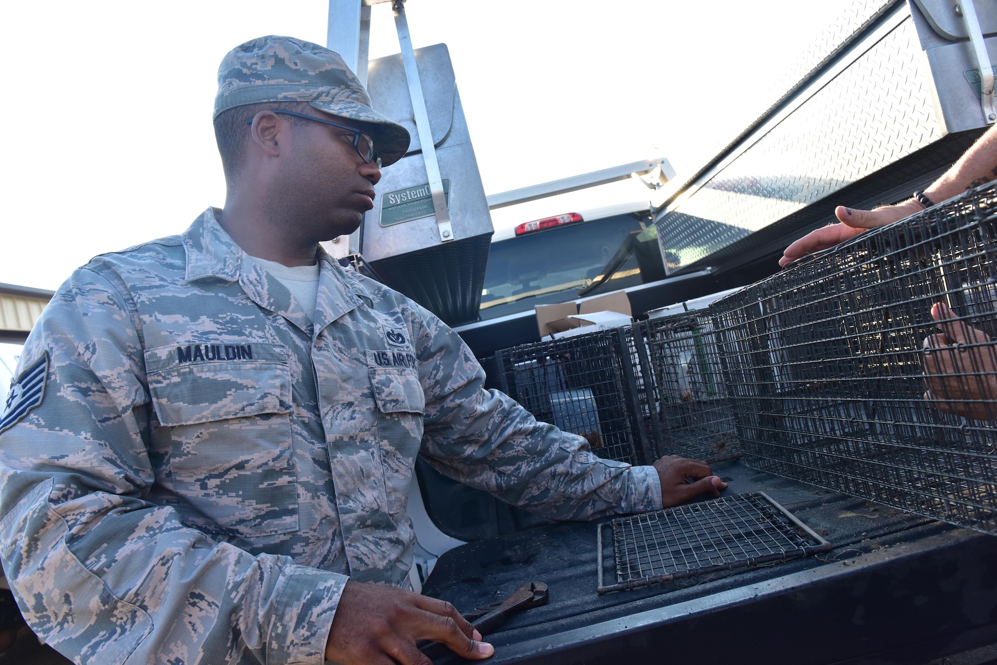 U.S. Air Force Tech. Sgt. Richard Mauldin prepares a single-door trap Whiteman Air Force Base, Mo., Aug. 2, 2017.