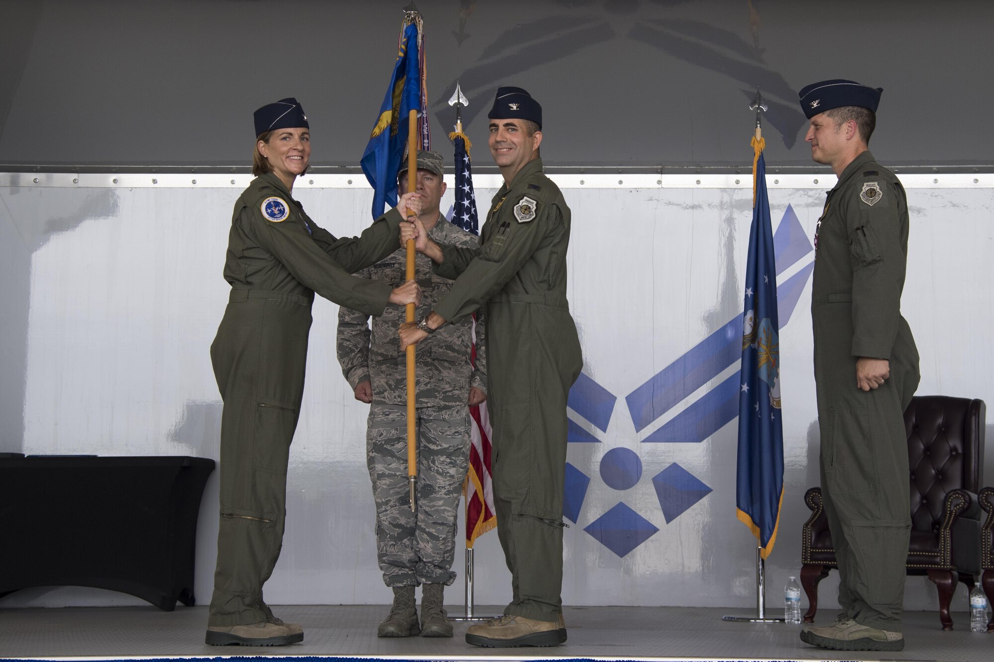 Col. Jennifer Short, 23d Wing commander, presents the 23d Fighter Group guidon to Col. Michael Curley, 23d FG incoming commander, during a change of command ceremony at Moody Air Force Base, Ga., Aug. 4, 2017. Curley was the Chief of the Training, Exercises, and Readiness Division at Headquarters U.S. Air Forces in Europe. (U.S. Air Force photo by Staff Sgt. Olivia Dominique)