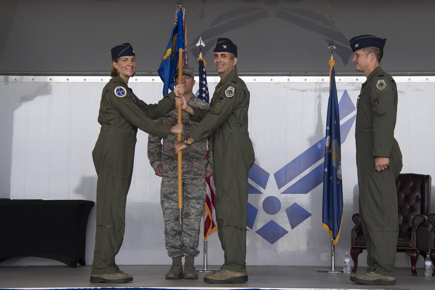 Col. Jennifer Short, 23d Wing commander, presents the 23d Fighter Group guidon to Col. Michael Curley, 23d FG incoming commander, during a change of command ceremony at Moody Air Force Base, Ga., Aug. 4, 2017. Curley was the Chief of the Training, Exercises, and Readiness Division at Headquarters U.S. Air Forces in Europe. (U.S. Air Force photo by Staff Sgt. Olivia Dominique)