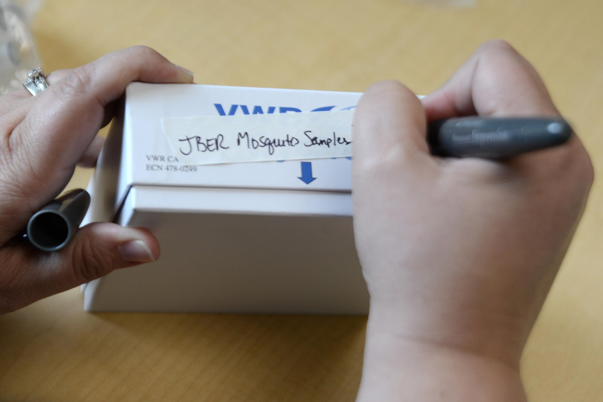 Doctor Clarise Starr, United States Air Force School of Aerospace Medicine deputy division chief, writes on the box of 67 preserved mosquitoes to be shipped to USAFSAM, Wright-Patterson Air Force Base, Ohio, from Joint Base Elmendorf-Richardson, Alaska, July 26, 2017. Scientists from AFSAM visited JBER to gather mosquitoes and ship them in three different preservatives for their new method of testing – genome sequencing, which requires the rapidly degenerating DNA/RNA.