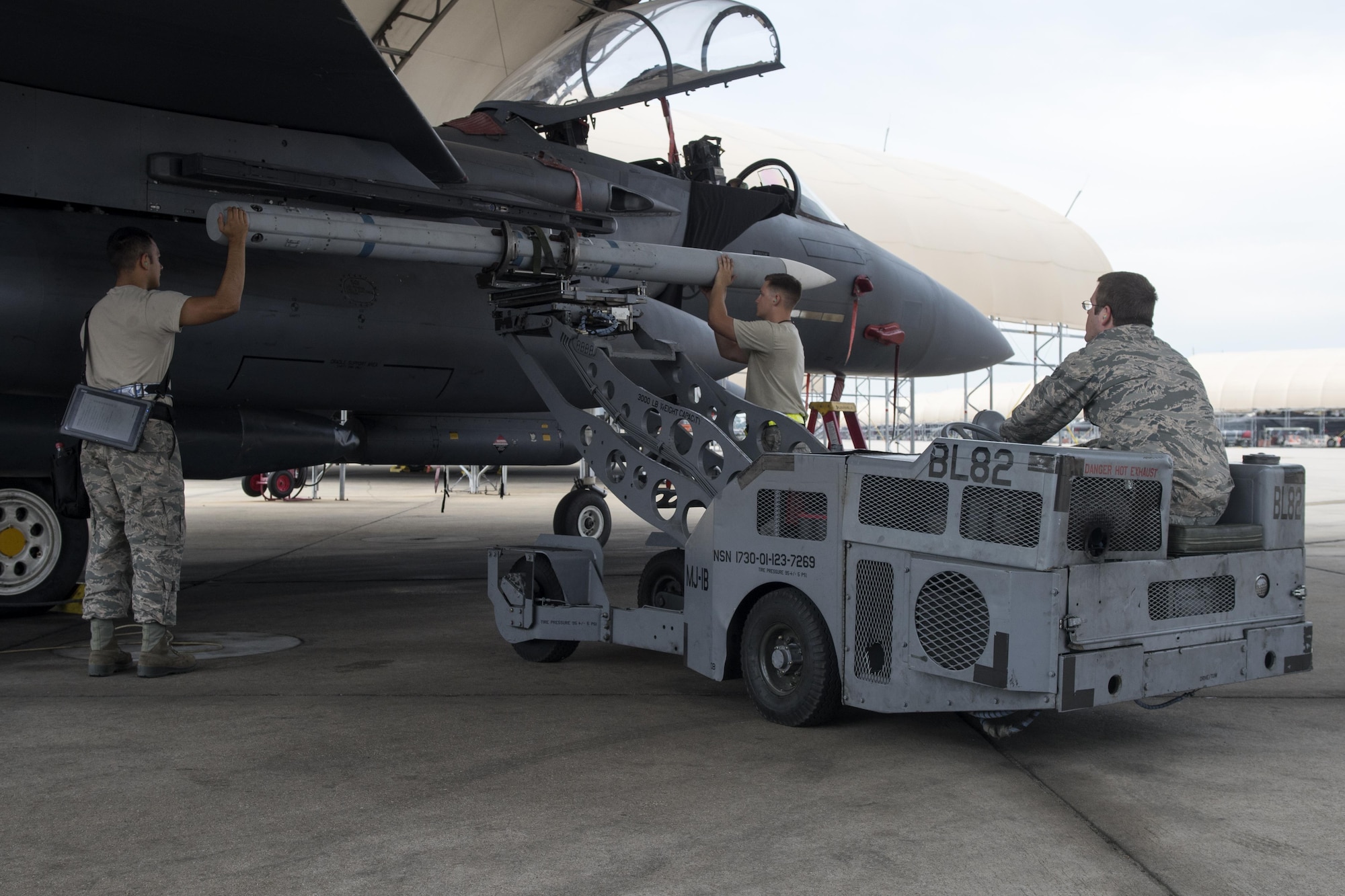 4th Aircraft Maintenance Squadron weapons load crew Airmen arm an F-15E Strike Eagle with an Aim-120 missile in preparation for exercise Combat Hammer, Aug. 3, 2017, at Seymour Johnson Air Force Base, North Carolina. F-15Es were loaded with missiles and bombs before flying to Hill Air Force Base, Utah, to participate in the exercise. (U.S. Air Force photo by Airman 1st Class Shawna L. Keyes)
