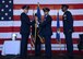 U.S. Air Force Maj. Gen. Thomas Bussiere, left, 8th Air Force commander, receives the 7th Bomb Wing guidon from Col. David Benson, center, during a change of command ceremony at Dyess Air Force Base, Texas, Aug. 4, 2017. After 24 years of service to the nation, Benson will retire from the Air Force. (U.S. Air Force photo by Senior Airman Katherine Miller)