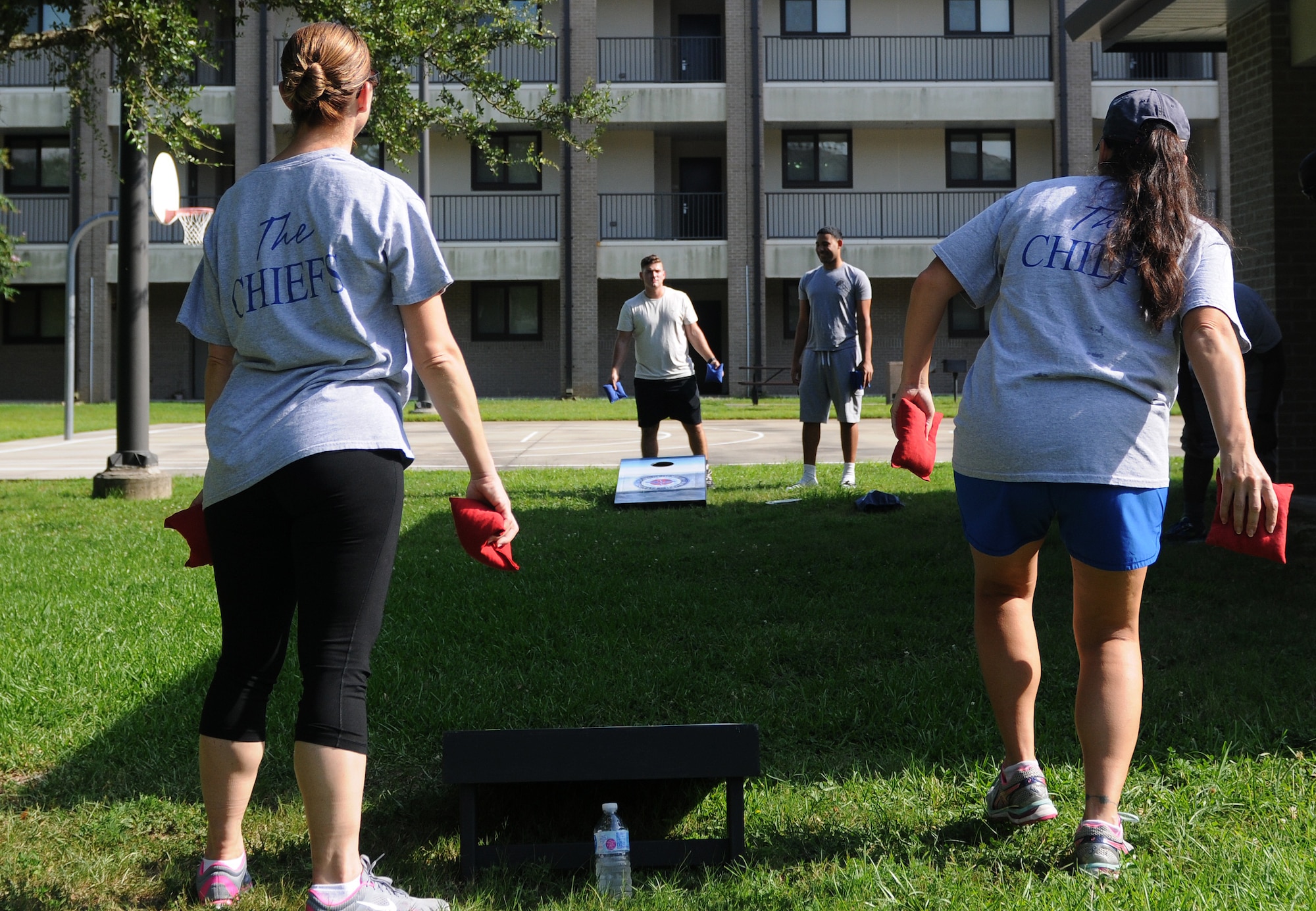 Keesler chief master sergeants and dorm residents play cornhole during the 2017 Dorm Bash at the Biloxi Hall courtyard August 1, 2017, on Keesler Air Force Base, Miss. The Dorm Bash was sponsored by the Keesler Chiefs Group to provide an opportunity for Keesler dorm residents to spend time together in fellowship. The chief master sergeants took home the Battle of the Bash Dragon award. (U.S. Air Force photo by Airman 1st Class Suzanna Plotnikov)