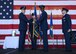 U.S. Air Force Maj. Gen. Thomas Bussiere, left, 8th Air Force commander, passes the 7th Bomb Wing guidon to Col. Brandon Parker, center, during a change of command ceremony at Dyess Air Force Base, Texas, Aug. 4, 2017. Parker assumed command from Col. David Benson and is now responsible for the health and welfare of over 12,000 active-duty members, civilian employees and family members. (U.S. Air Force photo by Senior Airman Katherine Miller)