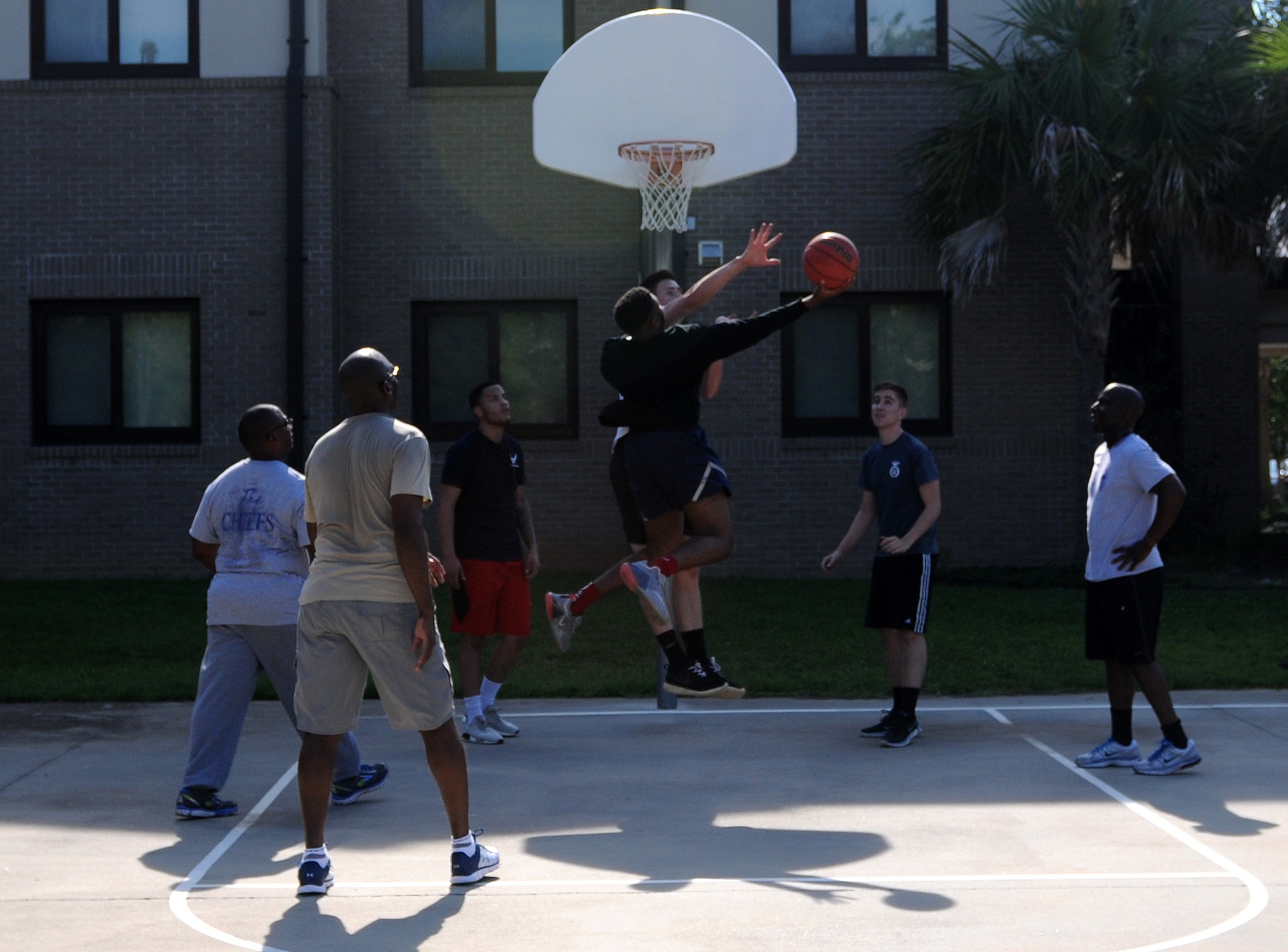 Keesler chief master sergeants and dorm residents play basketball during the 2017 Dorm Bash at the Biloxi Hall courtyard August 1, 2017, on Keesler Air Force Base, Miss. The Dorm Bash was sponsored by the Keesler Chiefs Group to provide an opportunity for Keesler dorm residents to spend time together in fellowship. The chief master sergeants took home the Battle of the Bash Dragon award. (U.S. Air Force photo by Airman 1st Class Suzanna Plotnikov)