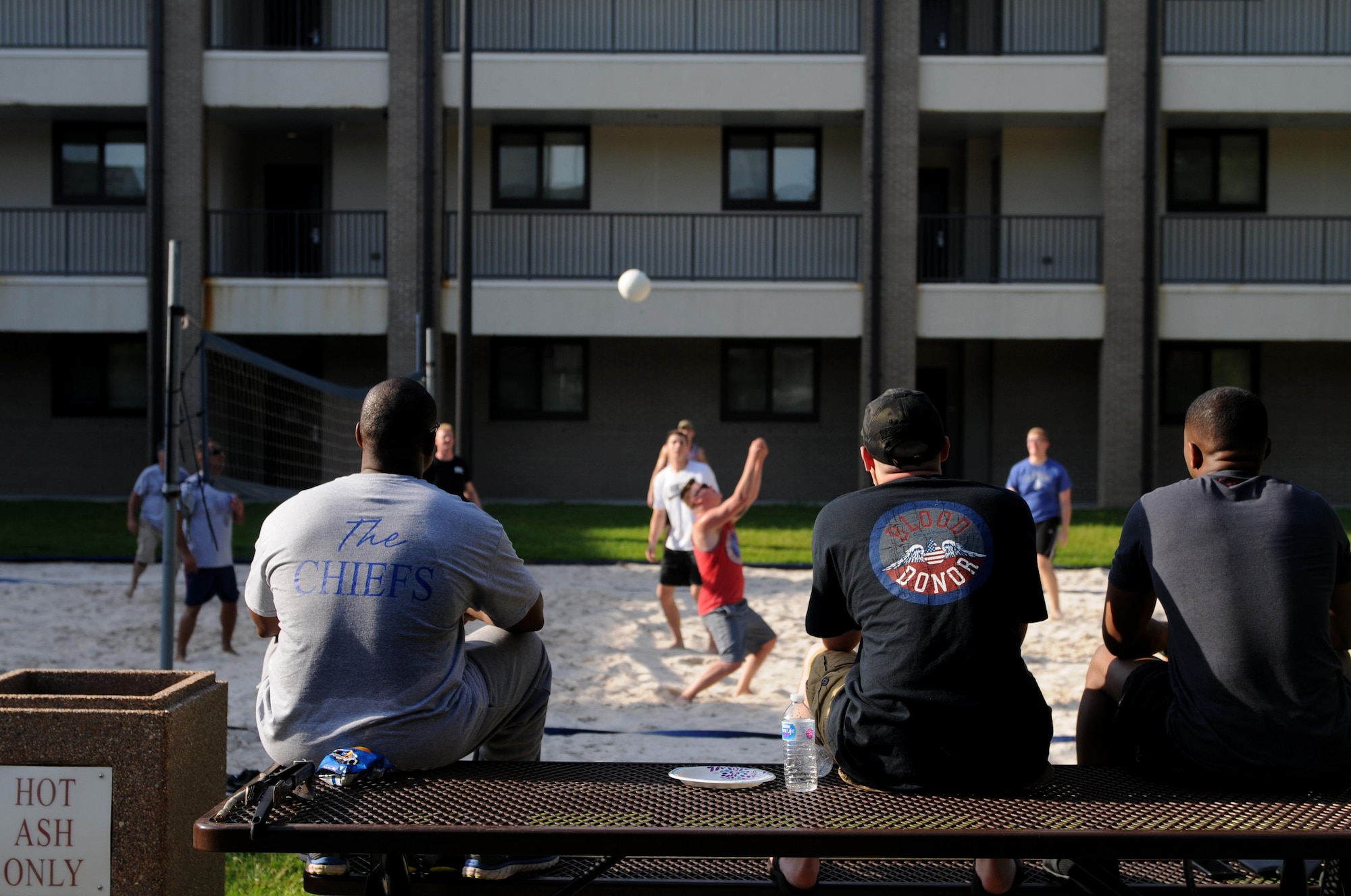 Spectators watch dorm residents and Keesler chief master sergeants play volleyball during the 2017 Dorm Bash at the Biloxi Hall courtyard August 1, 2017, on Keesler Air Force Base, Miss. The Dorm Bash was sponsored by the Keesler Chiefs Group to provide an opportunity for Keesler dorm residents to spend time together in fellowship. The chief master sergeants took home the Battle of the Bash Dragon award. (U.S. Air Force photo by Airman 1st Class Suzanna Plotnikov)
