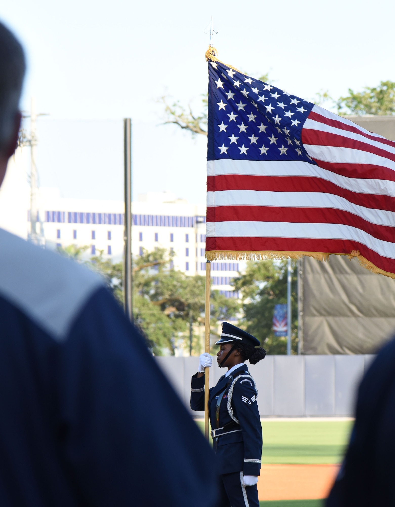 Senior Airman Quontalia Shephard, Keesler Air Force Base Honor Guard member, marches with the U.S. flag during the Biloxi Shuckers Minor League Baseball team’s military appreciation night July 31, 2017, in Biloxi, Miss. The Shuckers recognized and honored service members and their families for serving the nation. (U.S. Air Force photo by Kemberly Groue)
