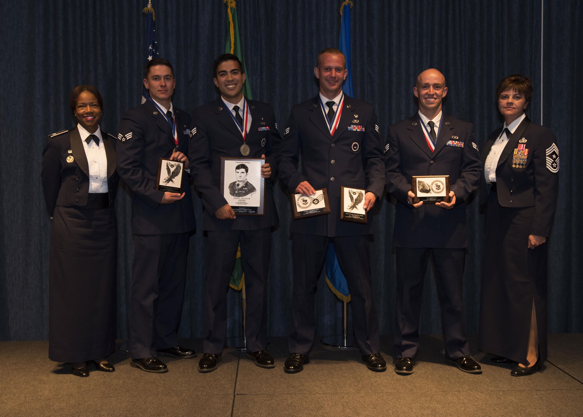 (From left to right) Col. Yvonne Spencer, 92nd Mission Support Group commander, Senior Airman Joshua Kalanick, 92nd Aerospace Medicine Squadron, Senior Airman Patrick Cruz, 22nd Training Squadron, Senior Airman Joseph St. Pierre, 66th Training Squadron, Senior Airman Jesus Ramos, 92nd Aircraft Maintenance Squadron, and Chief Master Sgt. Shannon Rix, 92nd Air Refueling Wing command chief, pose for a top graduate group photo Aug. 1, 2017, at Fairchild Air Force Base, Washington. Airman Leadership School is an educational program designed to develop enlisted Airmen into front-line supervisors.