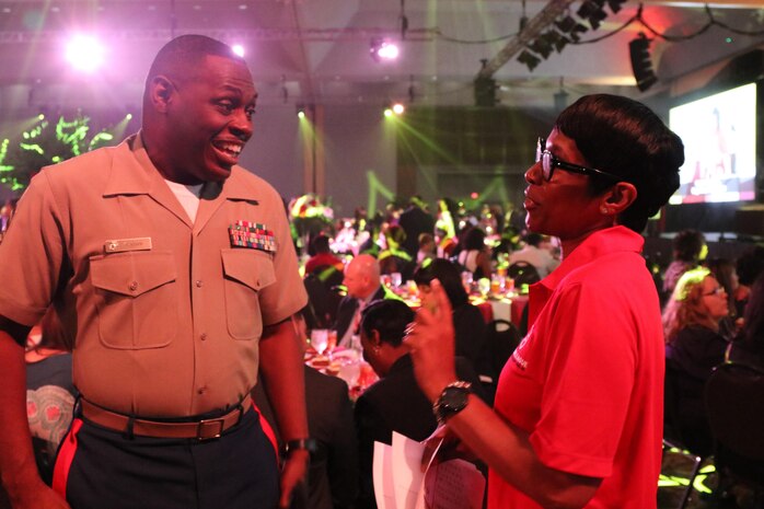 Master Sgt. Damian Cason, the community engagement chief at Marine Corps Recruiting Command in Quantico, Va., interacts with a volunteer at the National Urban League Women of Power Awards Luncheon in St. Louis, Mo., on July 27, 2017. The theme of this year’s National Urban League National Conference was “Save Our Cities: Education, Jobs and Justice.” (U.S. Marine Corps photo by Sgt. Jennifer Webster/Released)