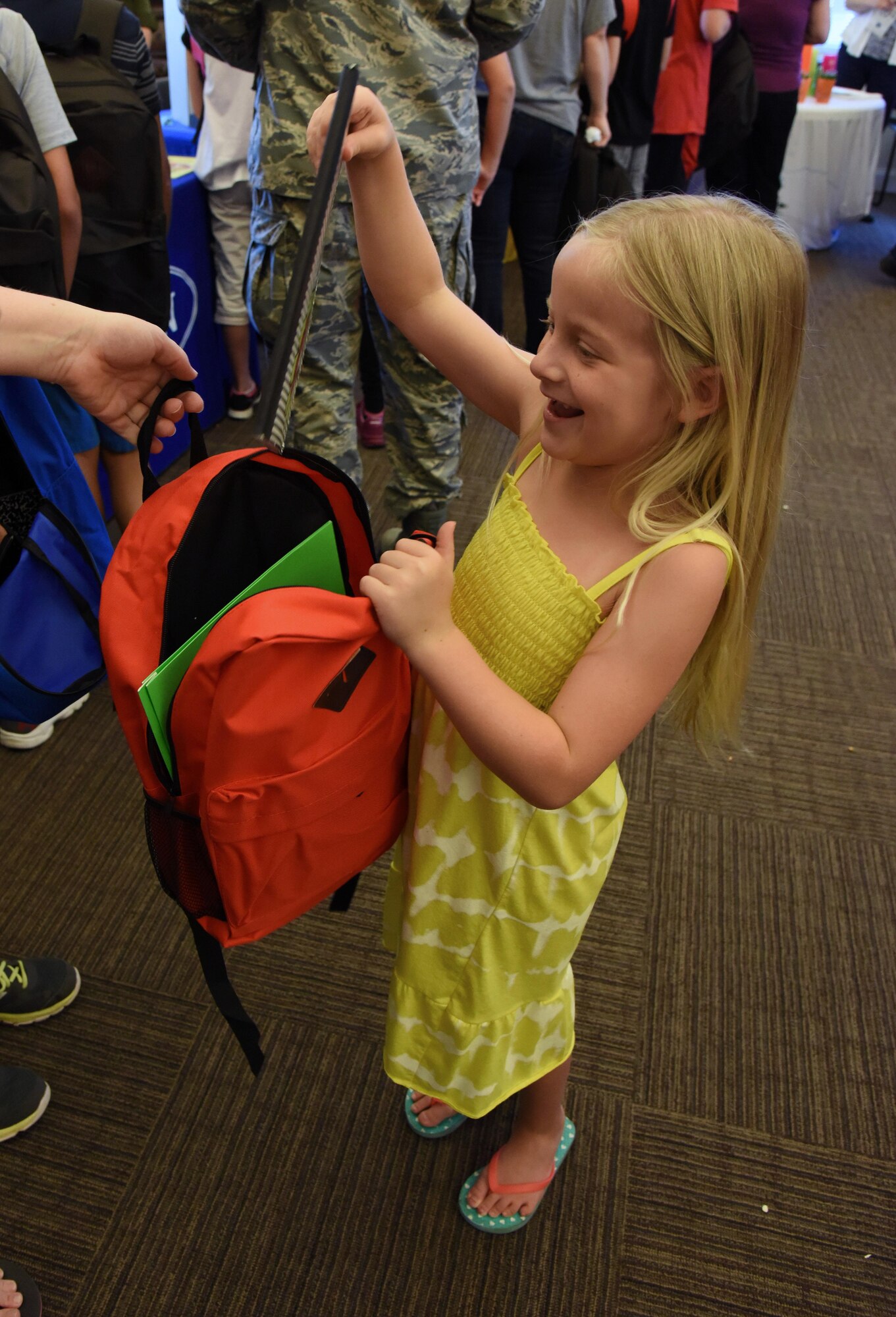 Isabella Tarpley, daughter of Airman Eric Tarpley, 335th Training Squadron student, inspects a notebook in her backpack during a back-to-school event sponsored by Operation Homefront in the Bay Ridge Community Center Aug. 1, 2017, on Keesler Air Force Base, Miss. More than 4,000 items and 300 backpacks were donated to 120 military families. (U.S. Air Force photo by Kemberly Groue)