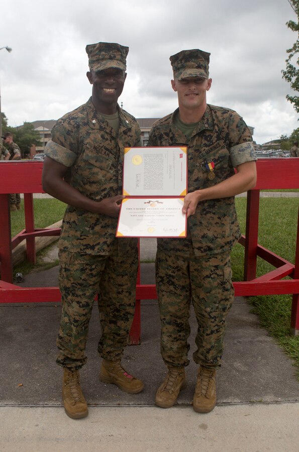 Sgt. Kevin Peach, an infantryman with 1st Battalion, 8th Marine Regiment, was awarded a Navy and Marine Corps Medal by Lt. Col. Reginald McClam, commanding officer of 1st Battalion, 8th Marine Regiment, during a battalion formation at Camp Lejeune, N.C., Aug. 8, 2017. Peach was awarded for rescuing a man from a burning vehicle on I-5 in California. (U.S. Marine Corps Photo by Sgt. Brandon Thomas)