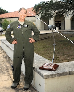 U.S. Air Force Tech. Sgt. Courtney poses
for a photo before the 558th Flying Training Squadron's Undergraduate
Remotely Piloted Aircraft Training Course graduation August 4, 2017, at
Joint Base San Antonio-Randolph, Texas. Tech. Sgt. Courtney is the
first-ever enlisted female to qualify as an RPA pilot. Name badges were
blurred due to Air Force limits on disclosure of identifying information for
RPA operators. (U.S. Air Force Illustration by Tech. Sgt. Ave I. Young)