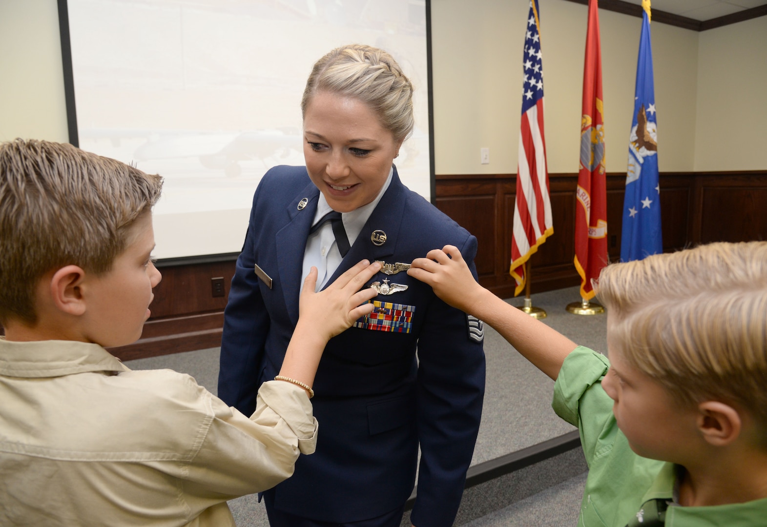 : U.S. Air Force Tech. Sgt. Courtney, has her
remotely piloted aircraft pilot wings pinned on by her sons David and Riley
during the 558th Flying Training Squadron's Undergraduate Remotely Piloted
Aircraft Training Course graduation August 4, 2017, at Joint Base San
Antonio-Randolph, Texas. Tech. Sgt. Courtney is the first-ever enlisted
female to qualify as an RPA pilot. Name badges were blurred due to Air Force
limits on disclosure of identifying information for RPA operators. (U.S. Air
Force Illustration by Tech. Sgt. Ave I. Young)