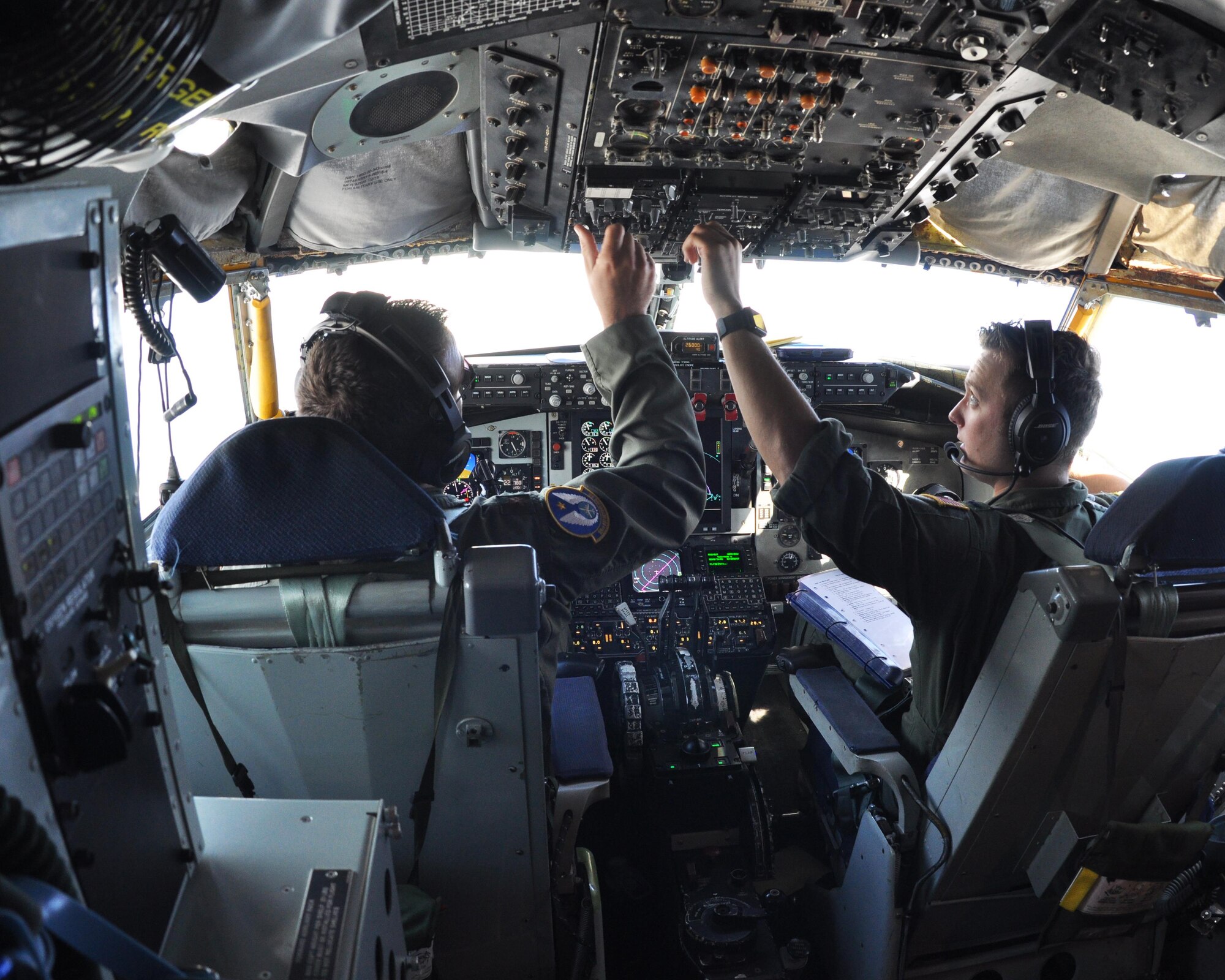 (Left to right) Maj. Brian Correll and 1st Lt. Alec Maloy, 18th Air Refueling Squadron pilots, perform checks on a KC-135 Stratotanker during an aerial refueling flight Aug. 3, 2017. The crew refueled F-16 Fighting Falcons from Buckley Air Force Base, Colo. (U.S. Air Force photo by Tech. Sgt. Abigail Klein)