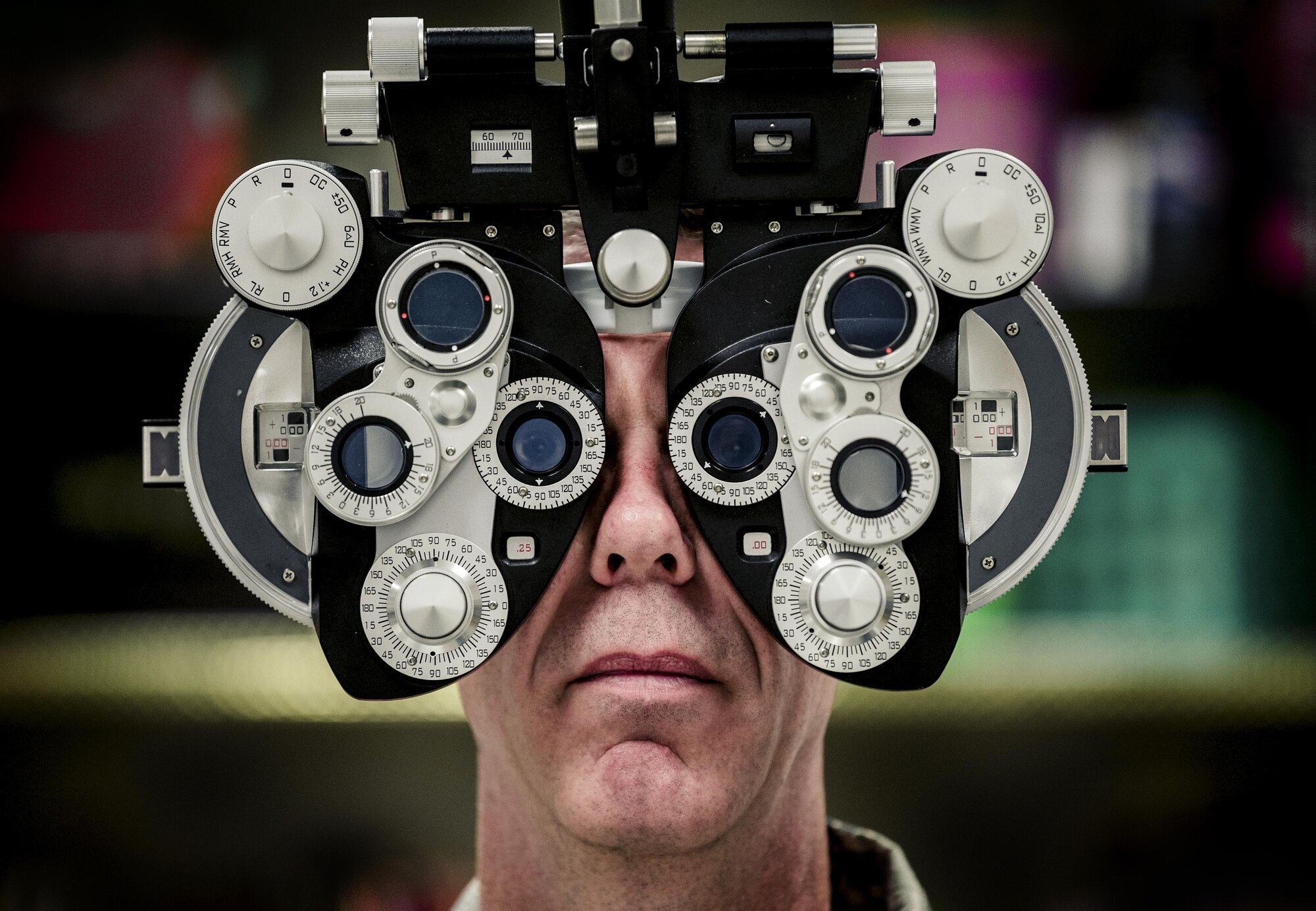 Lt. Col. David Miller, an optometrist assigned to the 442d Medical Squadron at Whiteman Air Force Base, Mo., assists in setting up a phoropter, which was used to give eye exams in Hayesville, N.C., Aug. 1, 2017. The Innovative Readiness Training program meets training requirements for active, reserve and National Guard members and units while addressing public and society needs. (U.S. Air National Guard photo by Staff Sgt. Ryan Campbell)