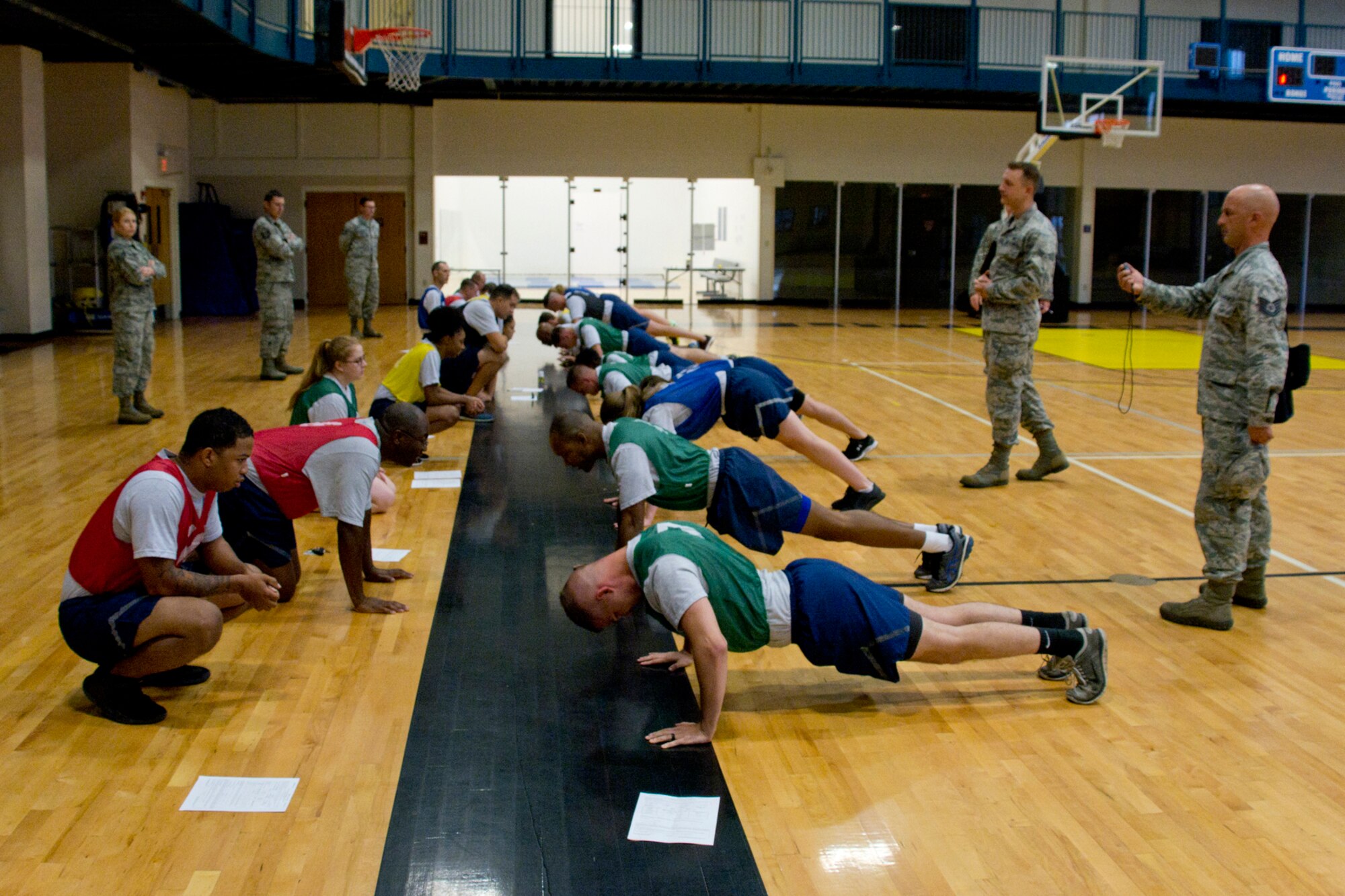 U.S. Air Force Reserve Airmen assigned to the 913th Airlift Group, perform push-ups during their physical fitness assessment test at Little Rock Air Force Base, Ark., Aug. 5, 2017. The Air Force uses overall composite fitness score and minimum scores per component based on aerobic fitness (1.5-mile timed run), body composition (abdominal circumference measurements) and muscular fitness components (push-ups and sit-ups) to determine overall fitness. (U.S. Air Force photo by Master Sgt. Jeff Walston/Released)
