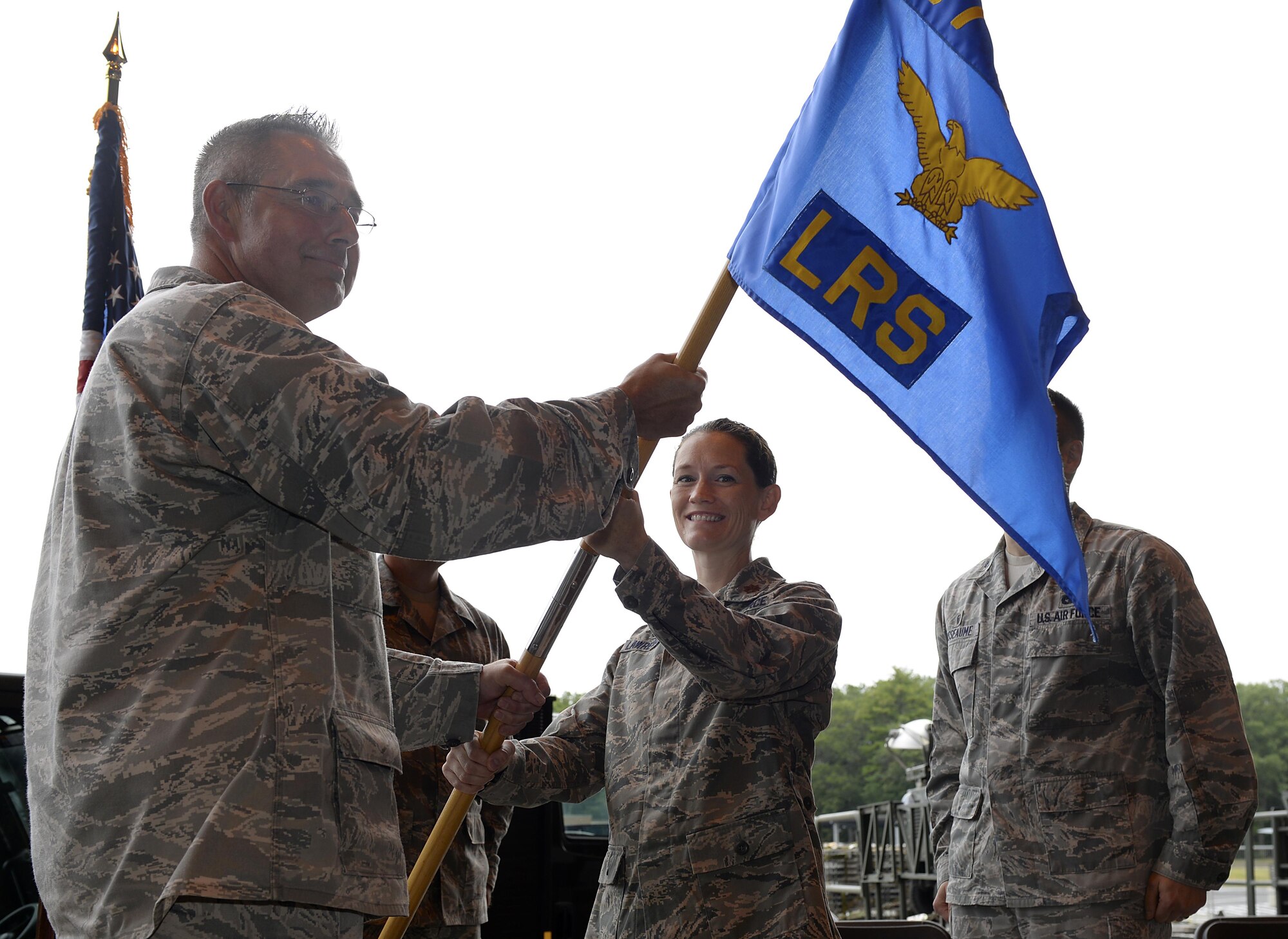 U.S. Air National Guard Maj. Emily C. Lawrence, receives the guidon from U.S. Air National Guard Lt. Col. Paul N. Loiselle, the mission support group commander, during a change of command ceremony August 5, 2017, at Pease Air National Guard Base, N.H.