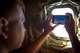 An Airman assigned to the 62nd Fighter Squadron, Luke Air Force Base, Ariz, takes a picture of F-35A Lighting IIs from an Arizona National Guard KC-135 Stratotanker Aug. 4, 2017. Several of the approximately 50 Airmen from the 62nd FS, on their way to a funeral for 2nd Lt. Charles E. Carlson, had never seen the F-35 from the air. (U.S. Air Force photo/Staff Sgt. Jensen Stidham)