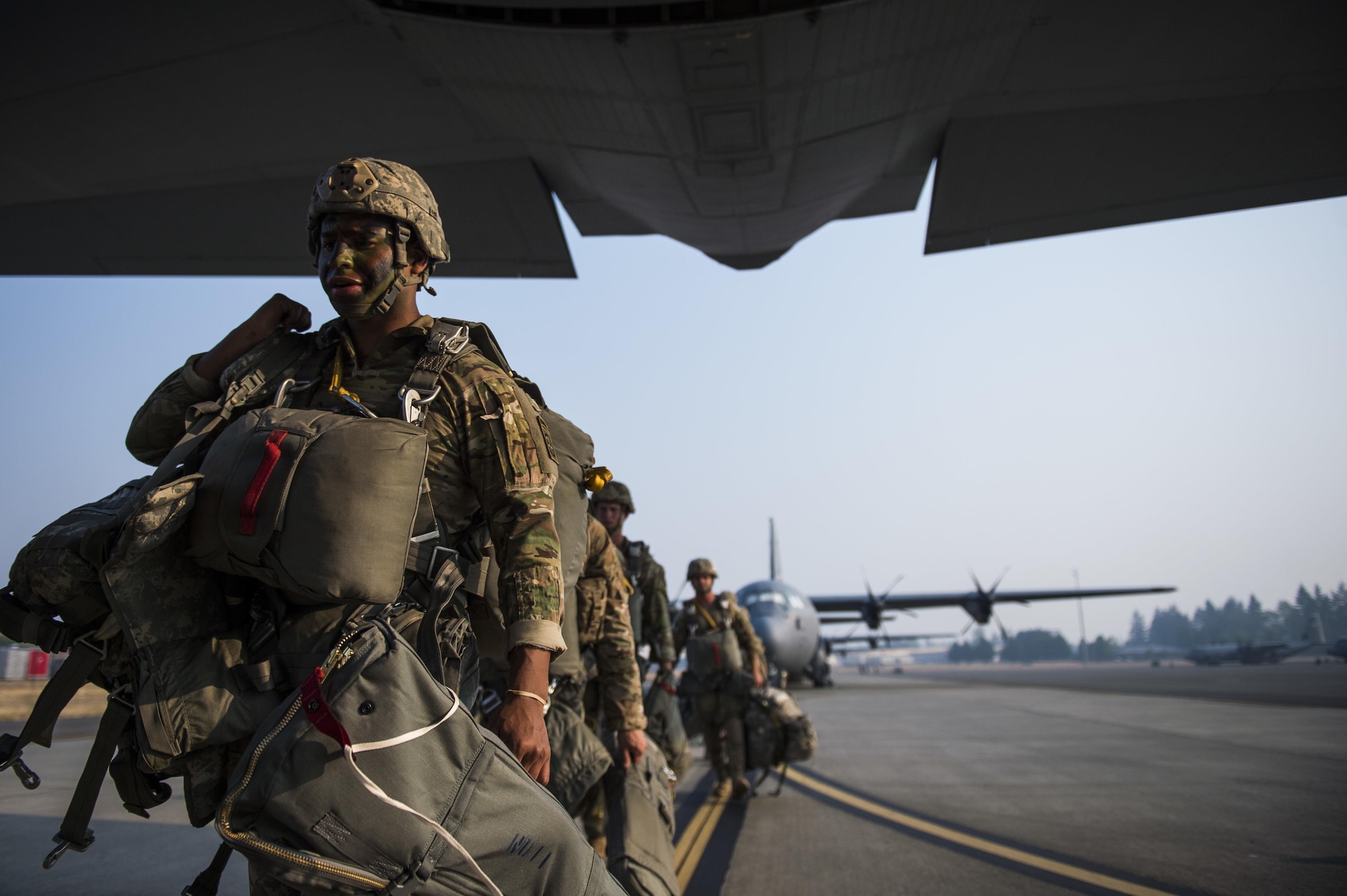 Soldiers boarding a C-130J for an air drop