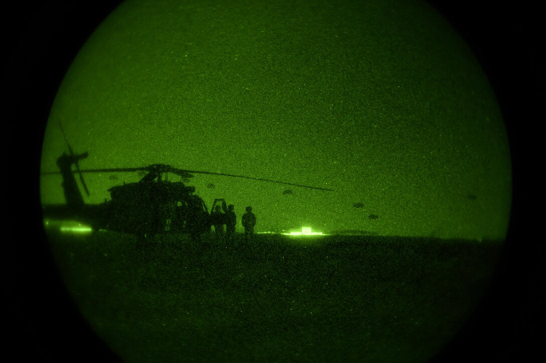 Night vision goggles view of helicopter and 82nd Airborne Division paratroopers