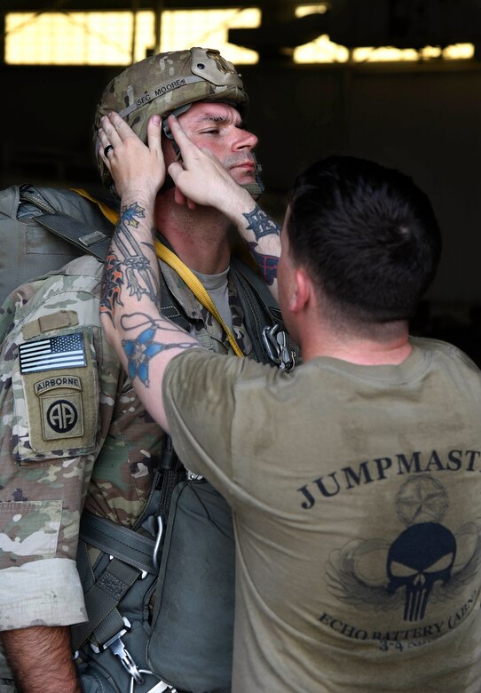 Soldier checking helmet before air drop