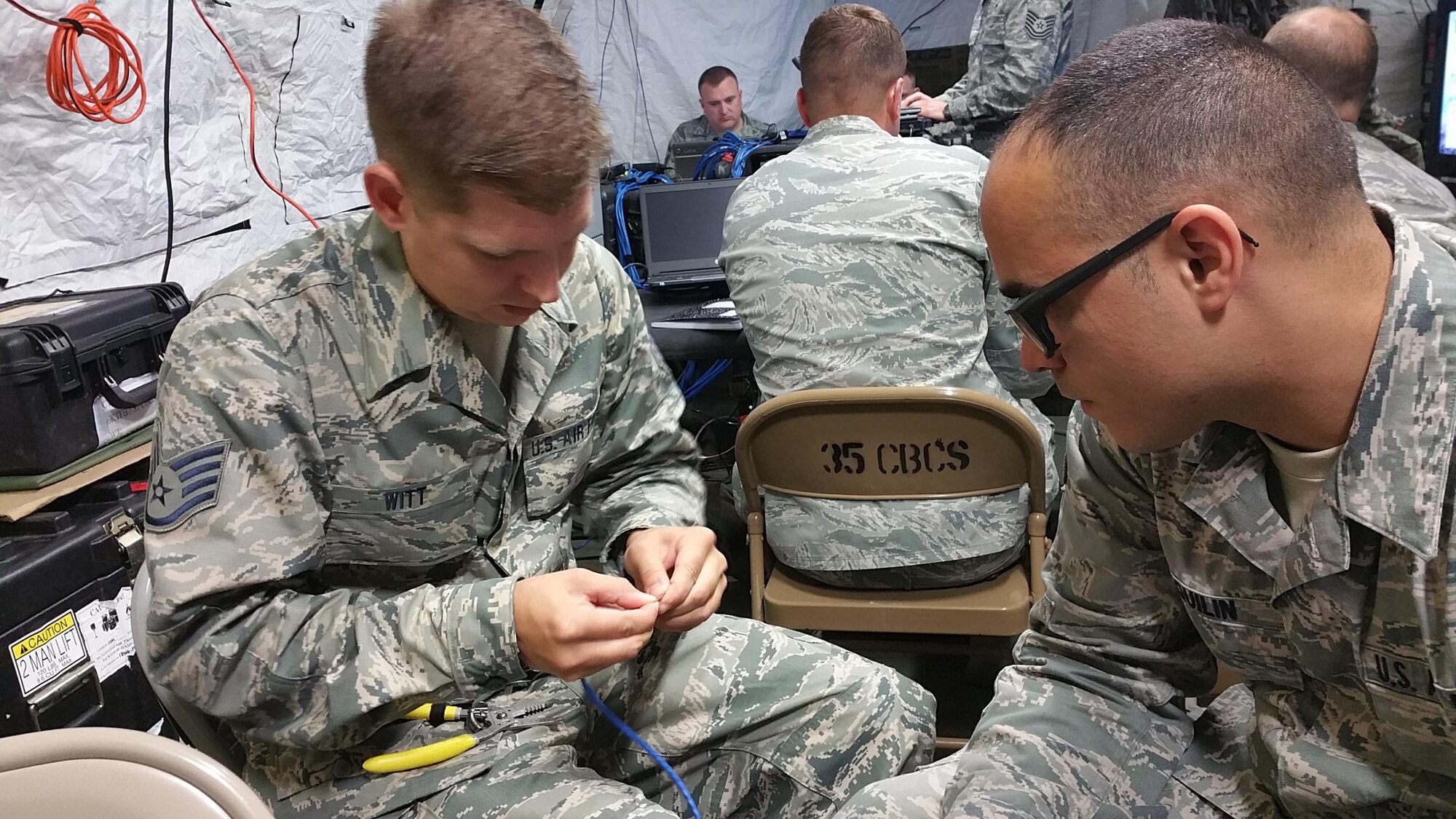 Client System Technician Journeyman Staff Sgt. Anthony Witt, 35th Combat Communications Squadron, teaches Radio Frequency Transmissions Systems Journeyman Senior Airman Erick Esquilin, 482nd Communications Squadron, how to best create data cable connections while in a simulated deployed environment during their Annual Tour at Homestead Air Reserve Base, Fla