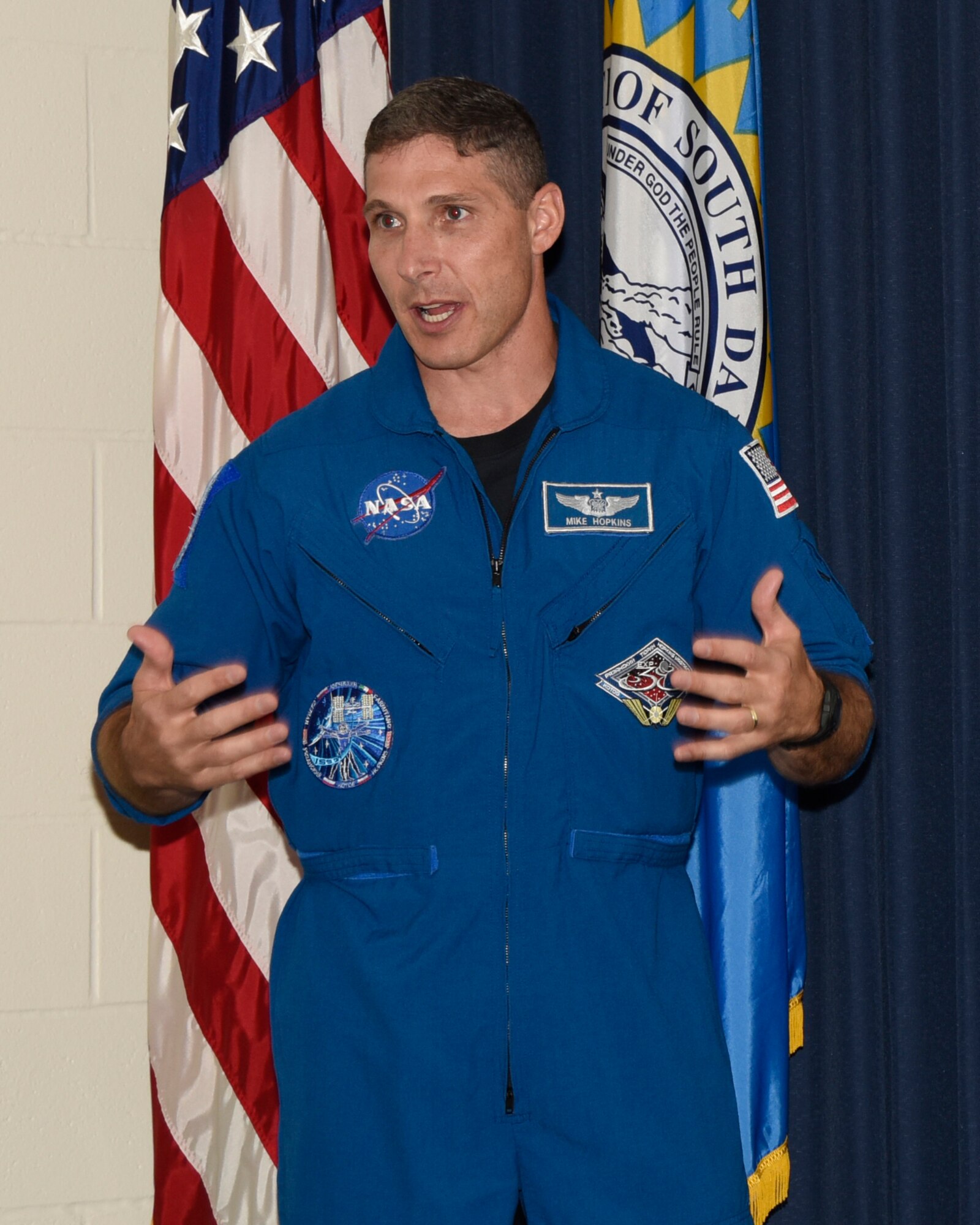 Colonel Michael Hopkins, NASA Astronaut, shared his experiences on the international space station and the affects of space on humans with members of the 114th Fighter Wing here, Aug. 4.  NASA is conducting research in preparation for a possible manned trip to Mars with a goal date of 2030. (U.S. Air National Guard photo by Master Sgt. Christopher Stewart/Released)