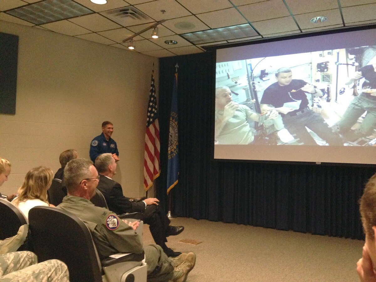 Colonel Michael Hopkins, NASA Astronaut, shared his experiences on the international space station and the effects of space on humans with members of the 114th Fighter Wing here, Aug. 4.  Hopkins described the MRE like food they ate during their mission, as well as the experience of eating in micro gravity. (U.S. Air National Guard photo by Master Sgt. Christopher Stewart/Released)