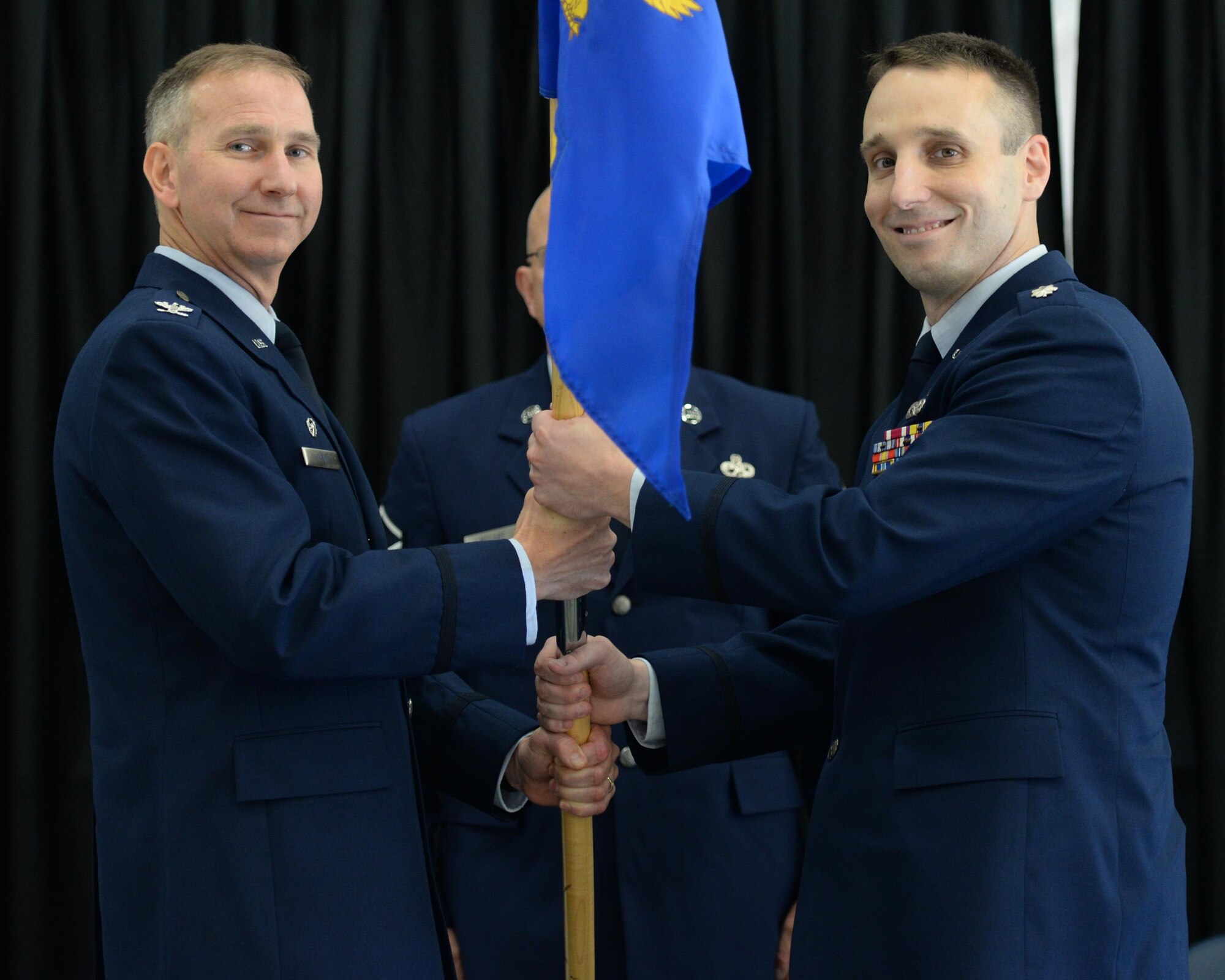 U.S. Air National Guard Col. James P. Ryan, 157th Air Refueling Wing commander, passes a guidon to Lt. Col. Brian R. Jusseaume during the 157th Maintenance Group change of command ceremony on Aug. 5, 2017, at Pease Air National Guard Base, N.H. Lt. Col. Paul M. Kell relinquished command of the 157th Maintenance Group to Jusseaume. (U.S. Air National Guard photo by Staff Sgt. Curtis J. Lenz)