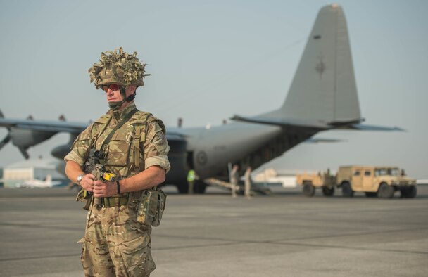 Royal Air Force senior aircraftsman Tom Raven provides security for a New Zealand C-130H Super Hercules during exercise Mobility Guardian at Moses Lake, Wash., Aug. 5, 2017. More than 650 international service members will work alongside more than 3,000 U.S. service members across Washington state from July 31 to Aug. 12, 2017. Mobility Guardian is Air Mobility Command’s premier exercise, providing an opportunity for the Mobility Air Forces to train with joint and international partners in airlift, air refueling, aeromedical evacuation and mobility support. (U.S. Air Force photo/Staff Sgt. Robert Hicks)